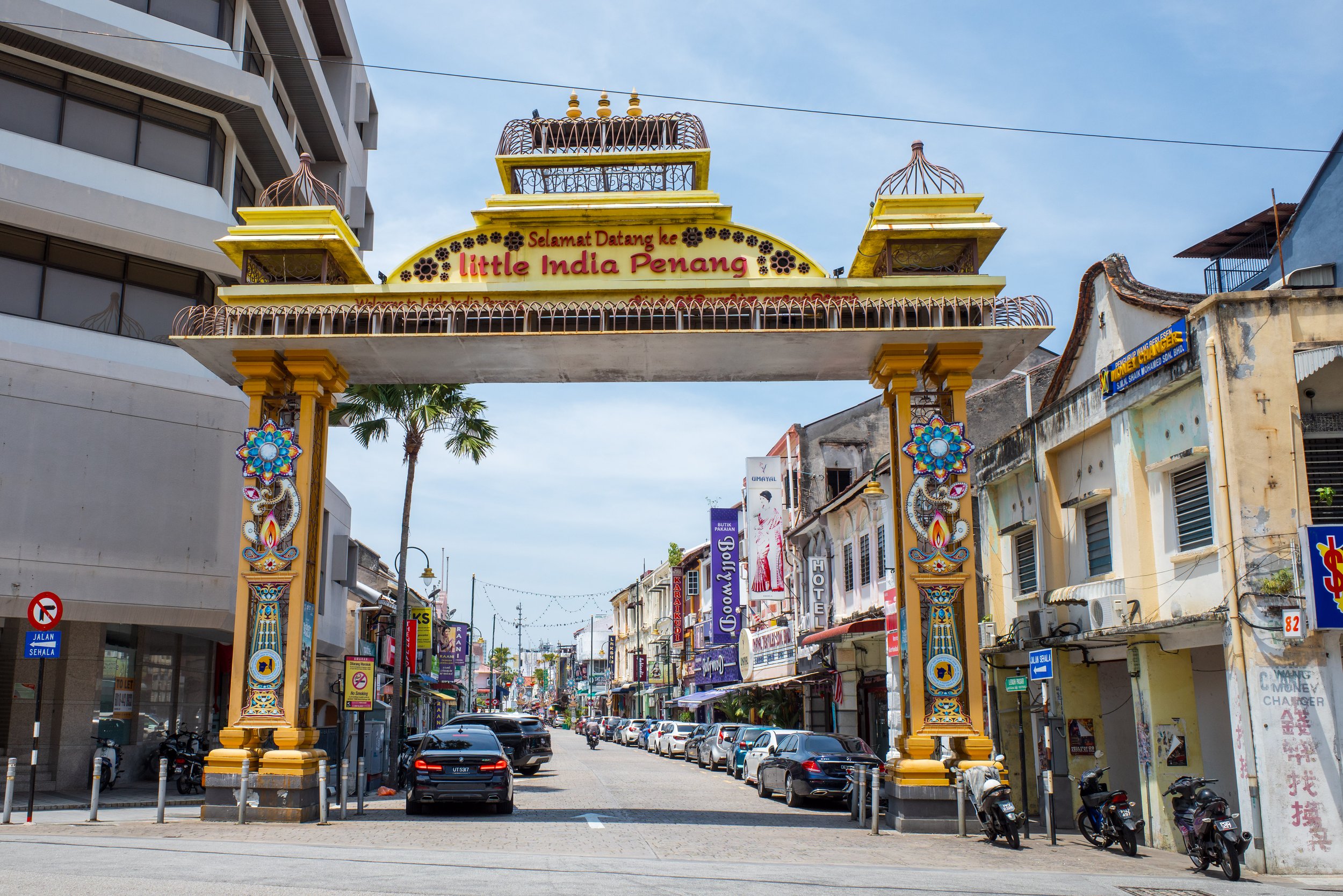 An archway over a road that says Little India Penang.