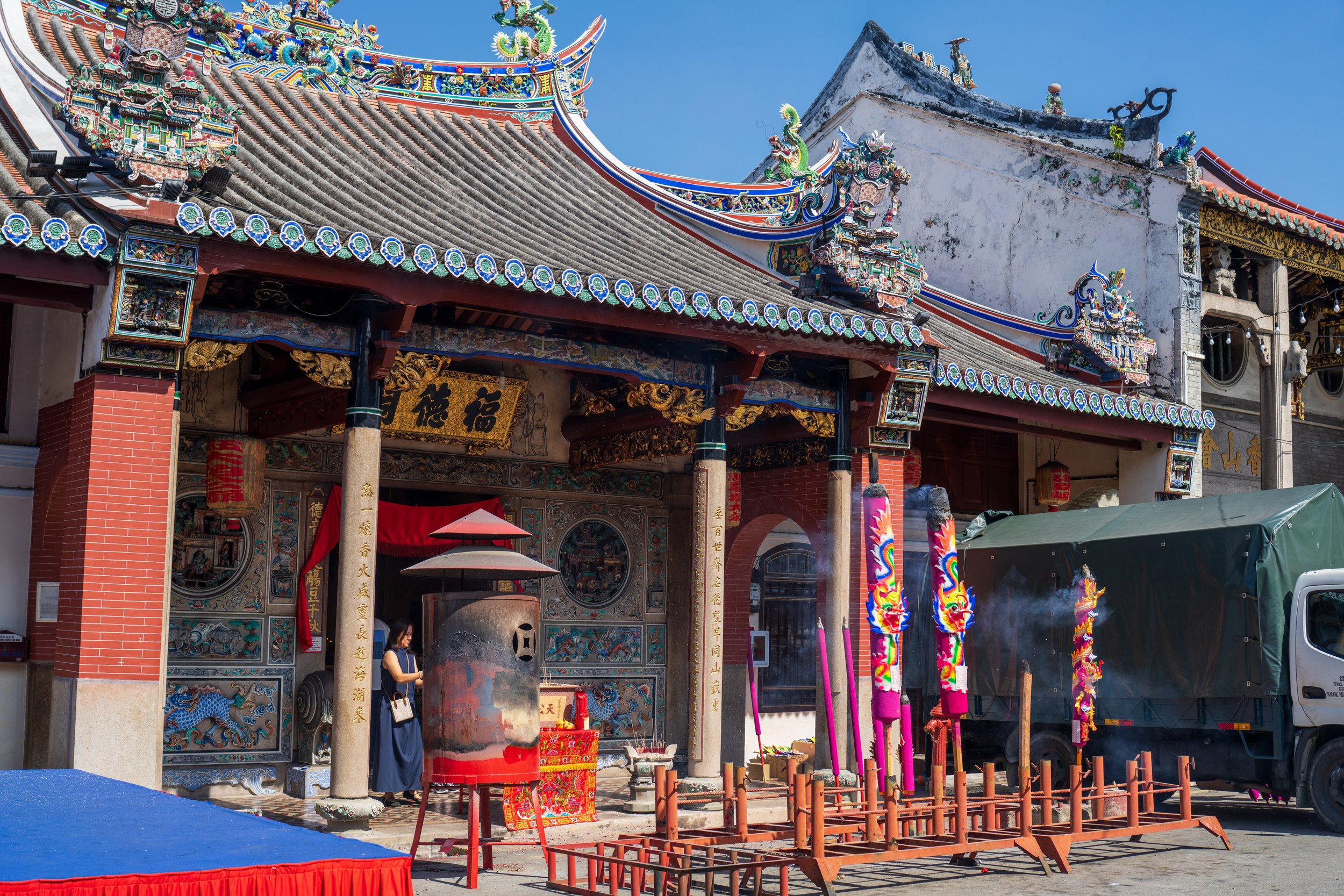 An ornate temple building with decorations in front.