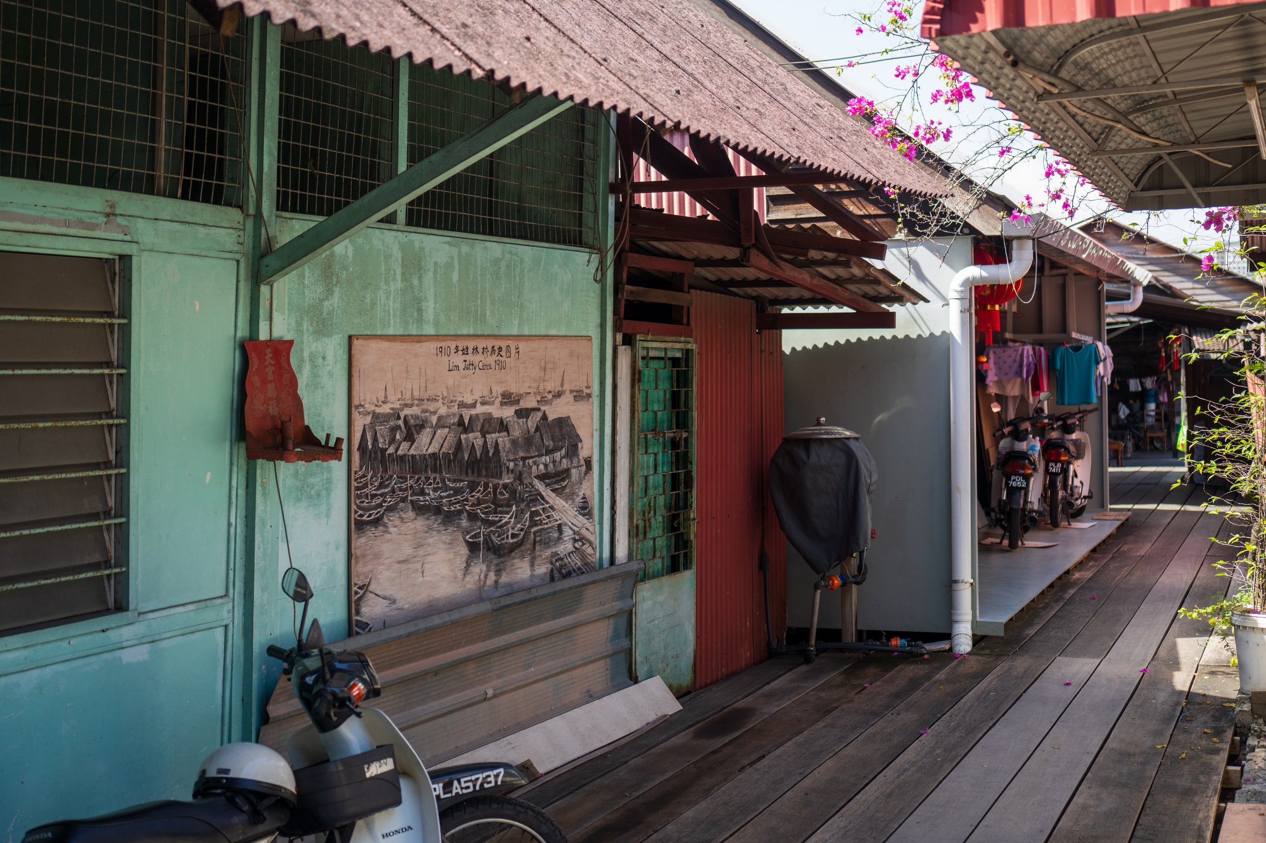 A green exterior wall with a drawing of boats on it.