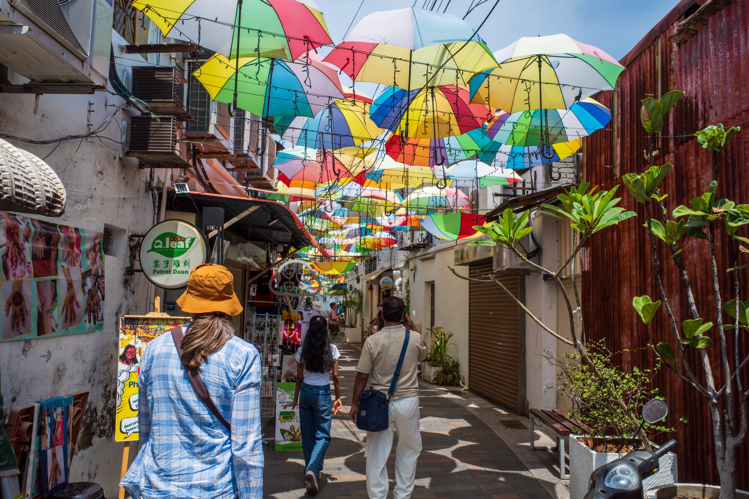 Nicole walking under colorful umbrellas.