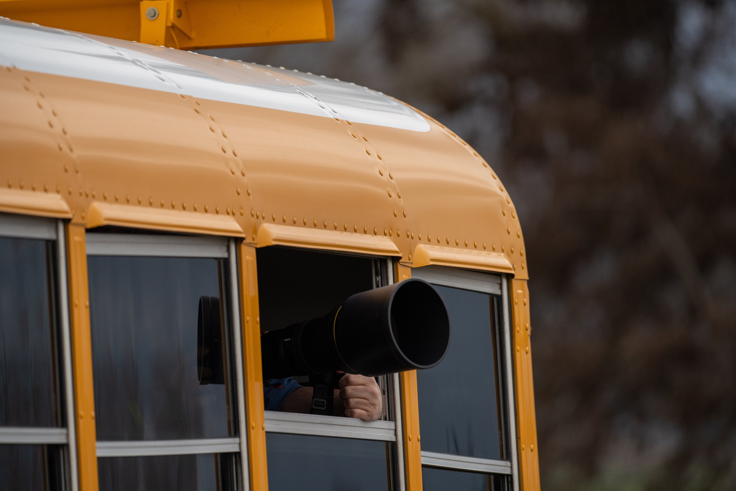  A photographer shooting out of the bus window (photo/Jason Rafal) 