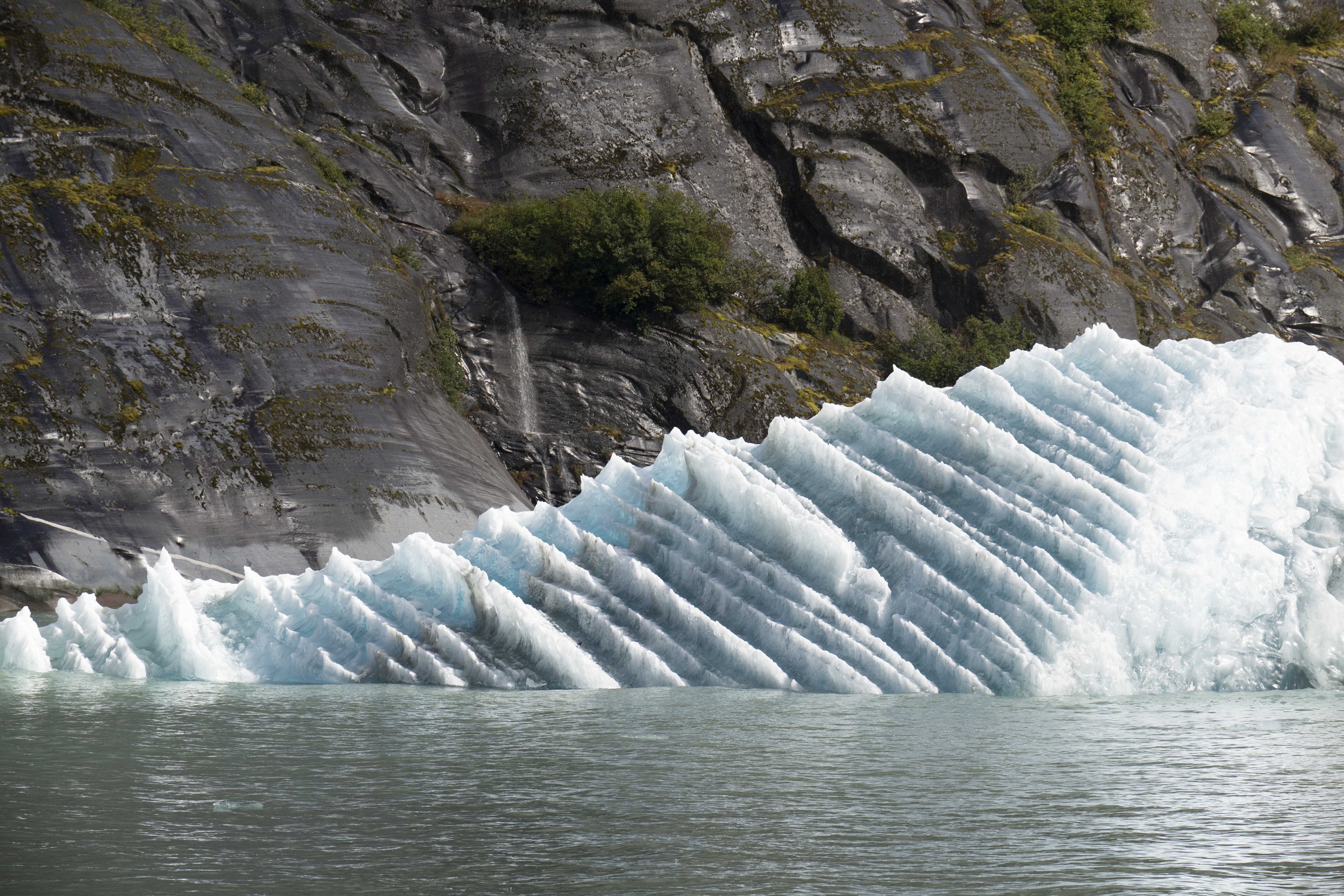 An iceberg with a sharp, dramatically sliced face.