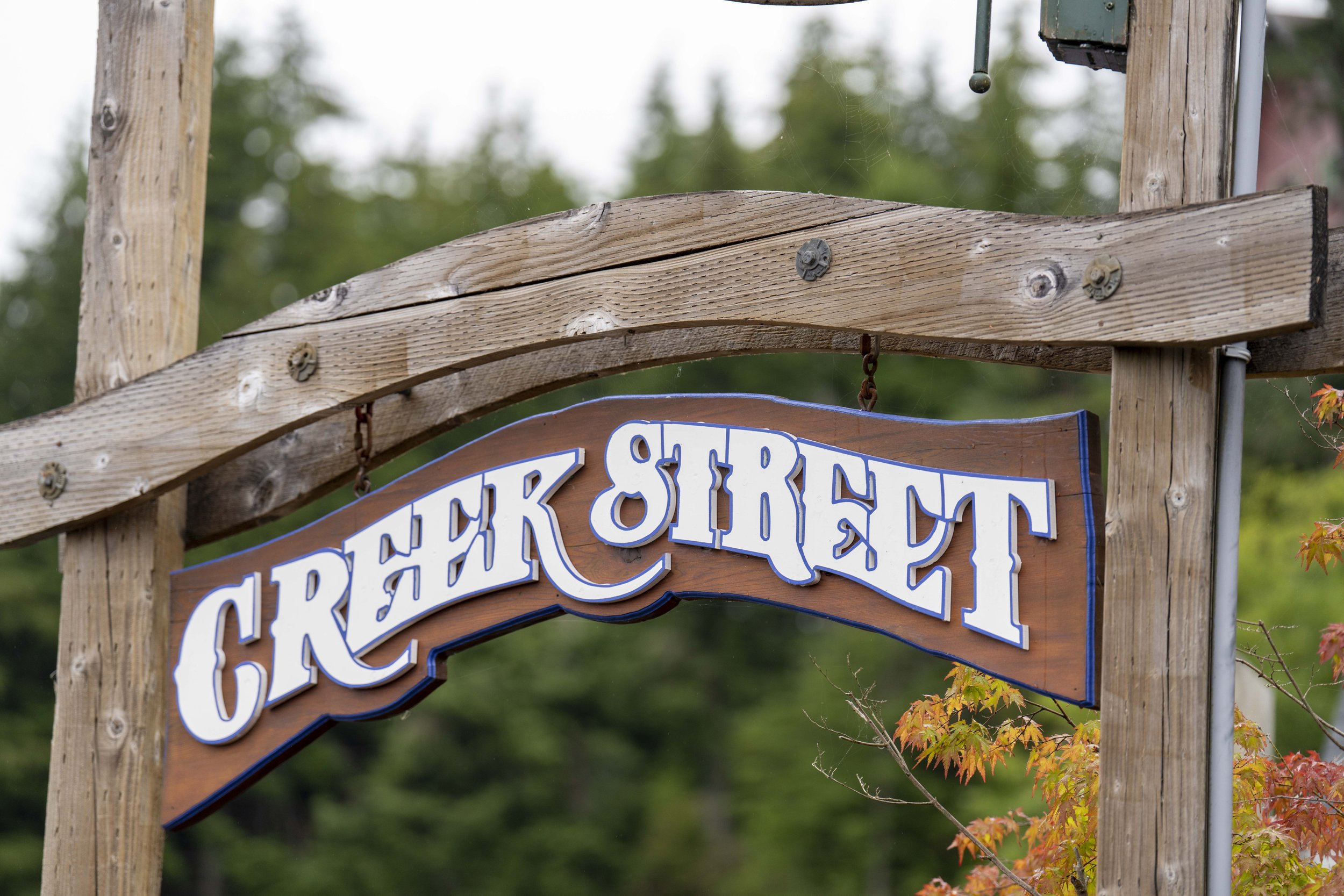 A wooden sign that says Creek Street.