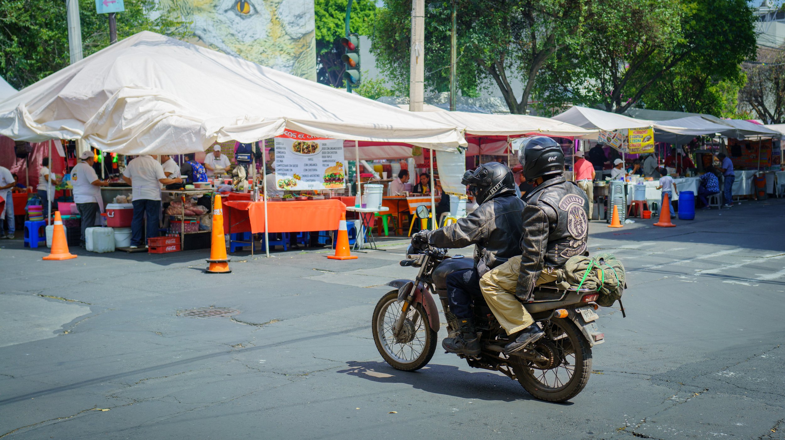 A typical scene of vendors with a mural in the background (photo/Jason Rafal)