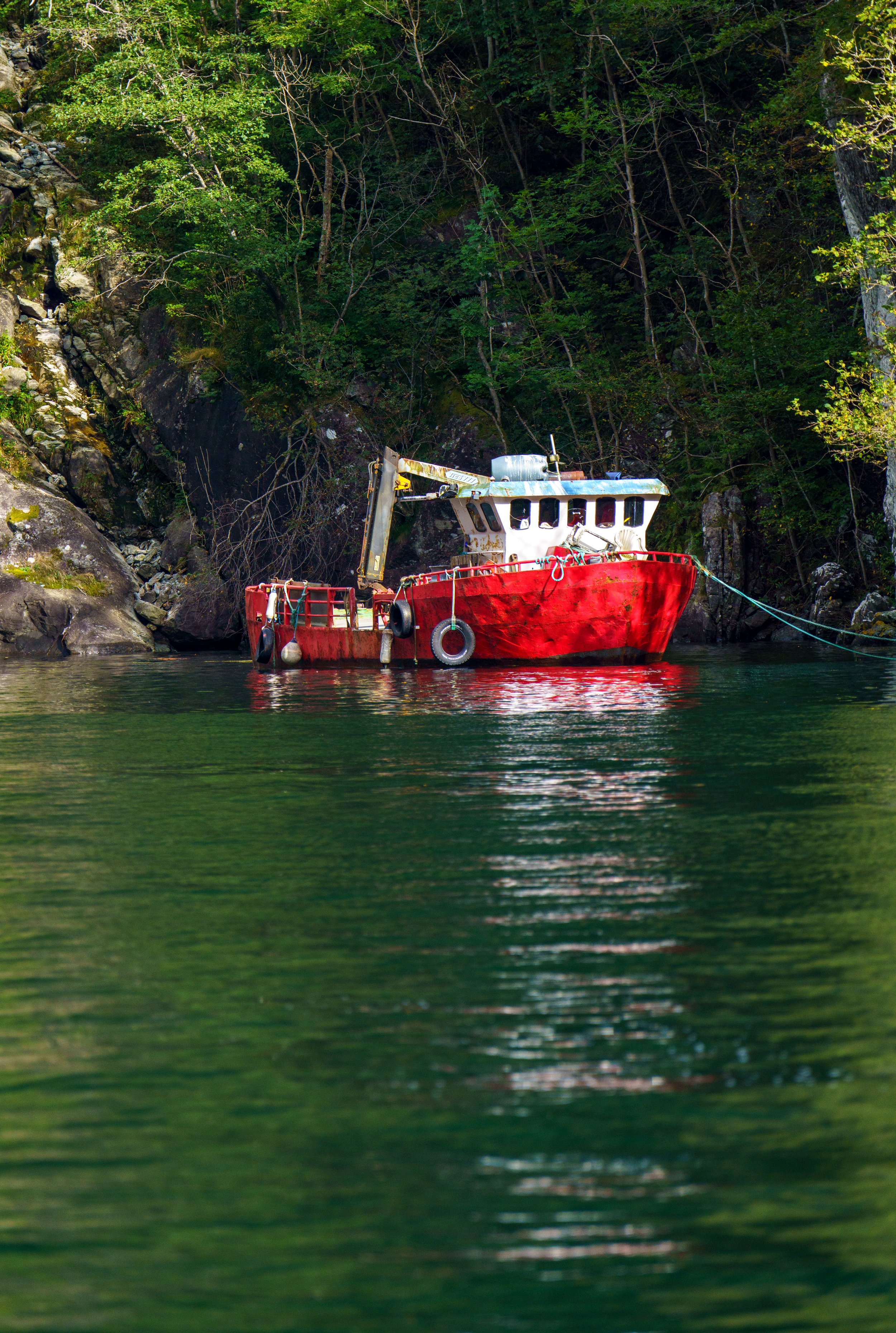 A photogenic red boat in the green water (photo/Jason Rafal)