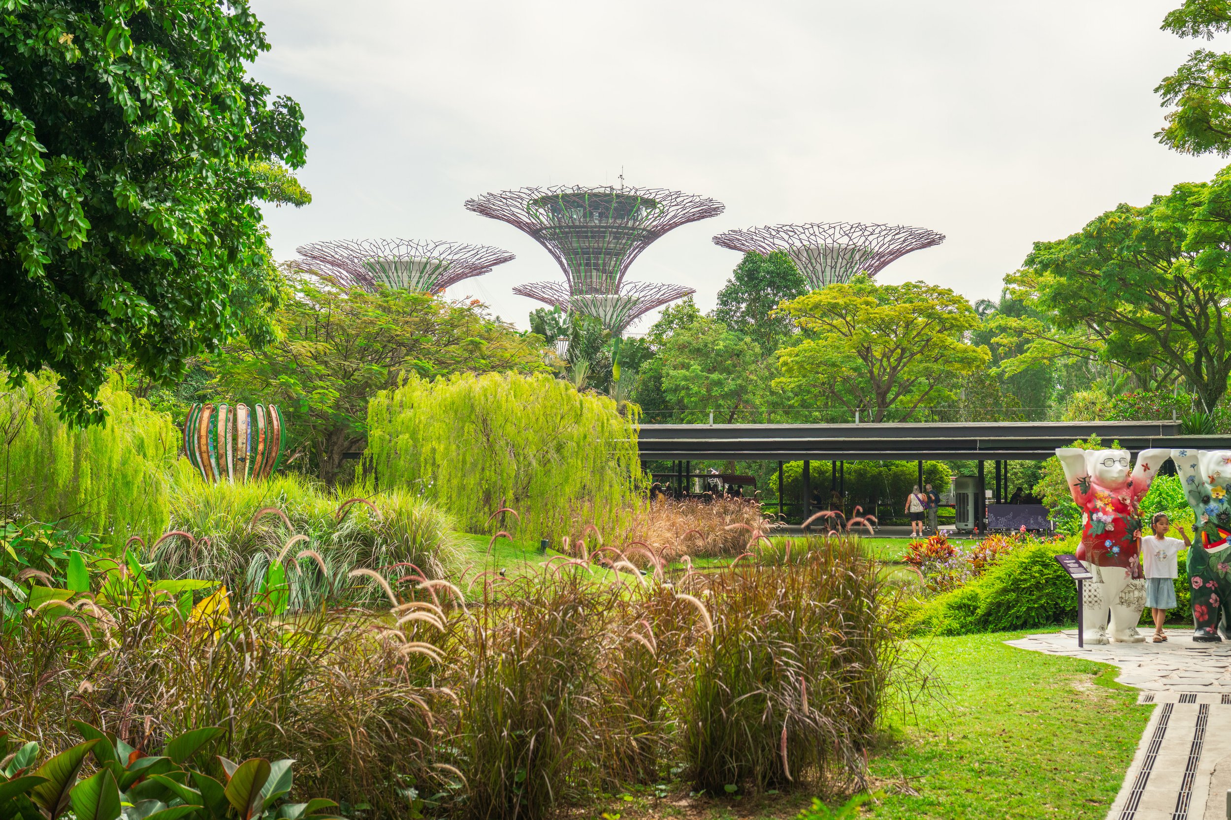 A lush garden with tree-shaped towers in the background.