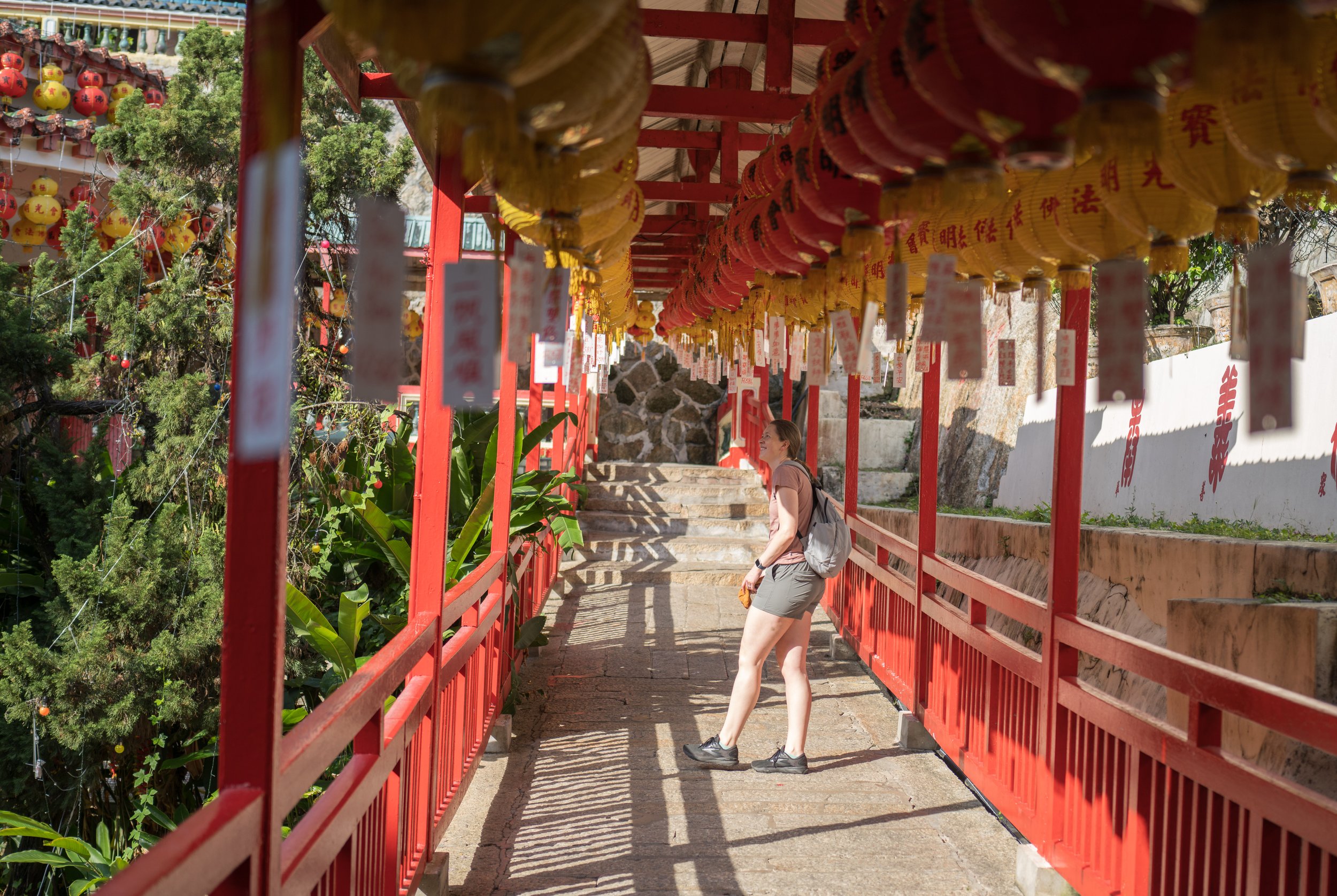 Nicole standing under hundreds of red lanterns in a walkway.