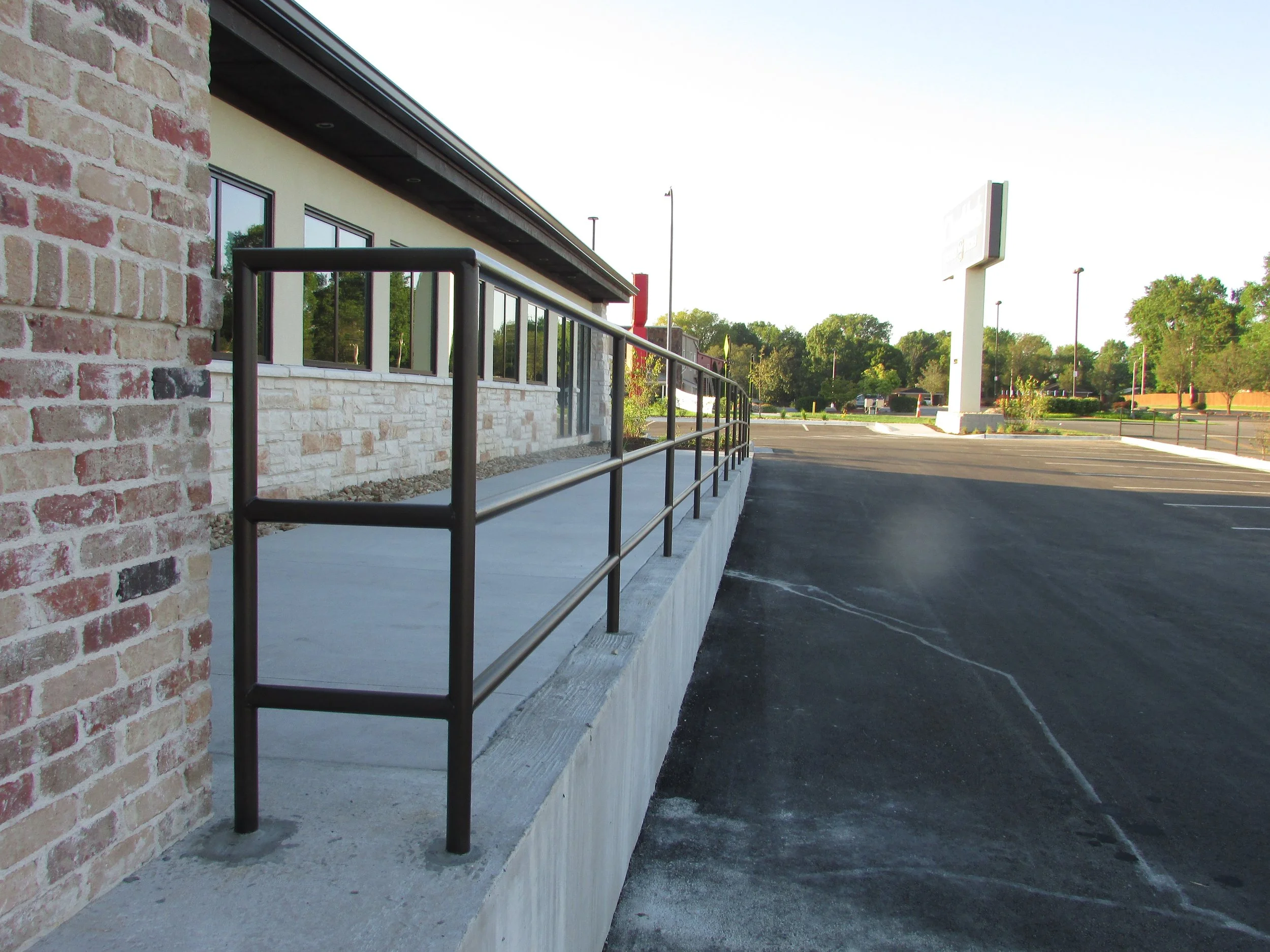 Round pipe handrail grouted in place