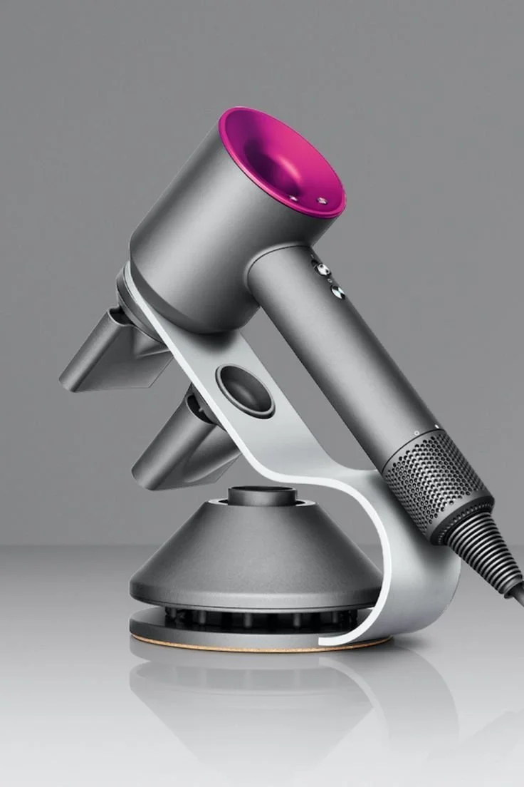 A futuristic, metallic microscope with a sleek design, featuring a magenta-colored top and a modern base.