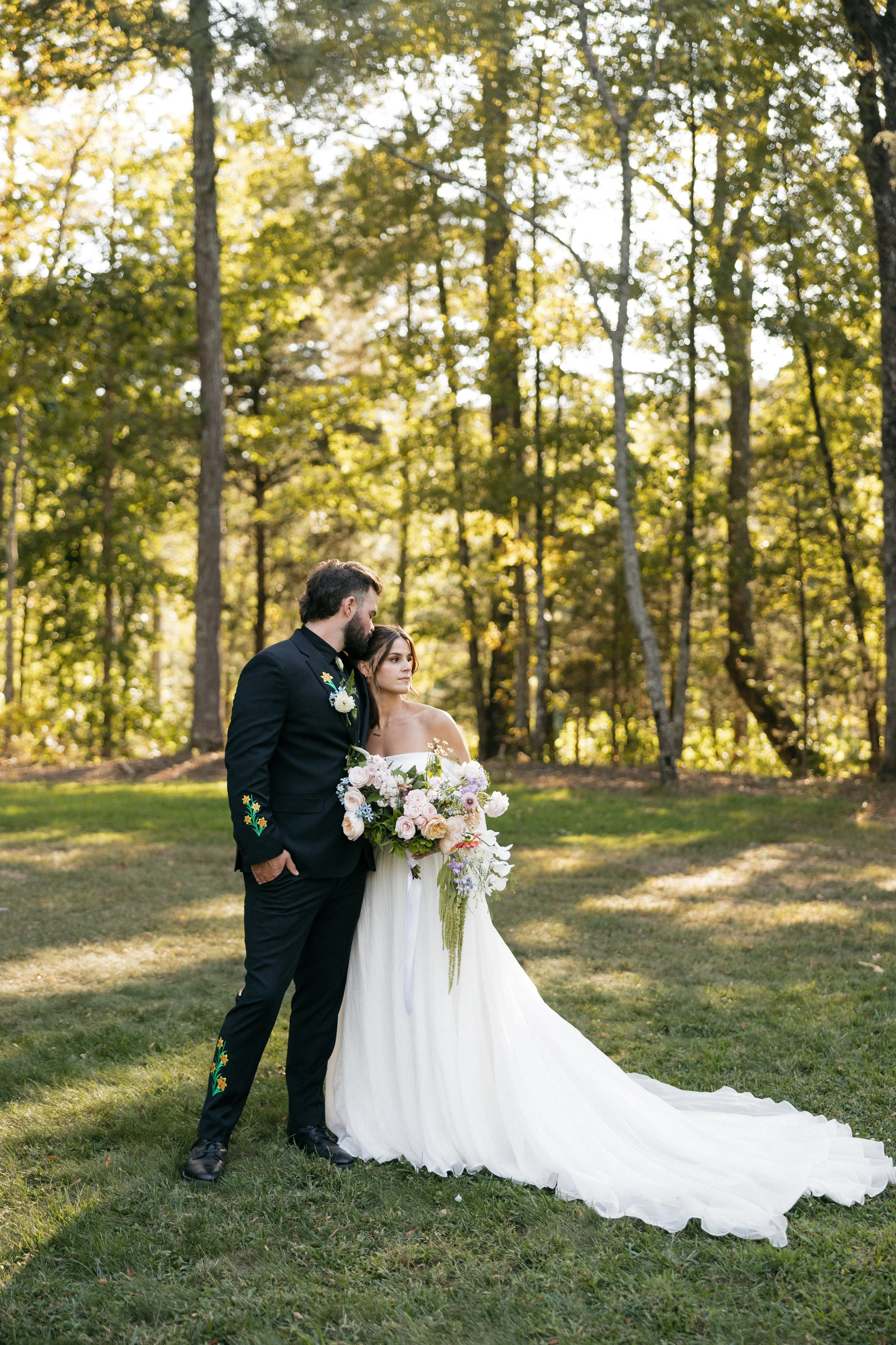Bride and groom outdoors with cascading garden-style bridal bouquet designed by Sweet South Flowers, Cleveland TN wedding florist (2).jpg
