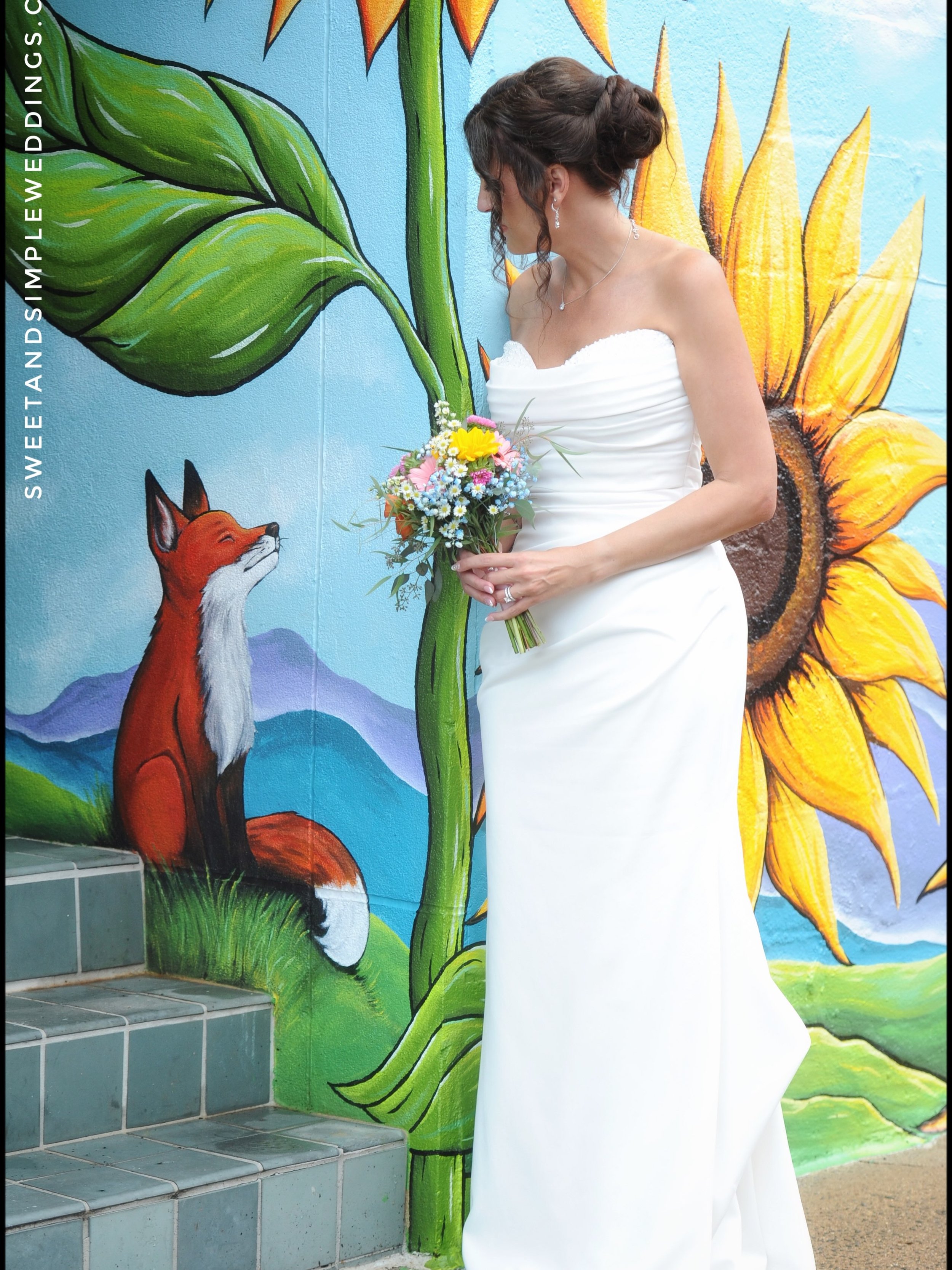 The Warrenton Sunflower mural brought a fairy tale vibe as Brenna &amp; Hank headed into Denim &amp; Pearls for their wedding reception, one of many charms in the #HeartofWarrenton that make it a perfect destination for your Sweet &amp; Simple Weddin