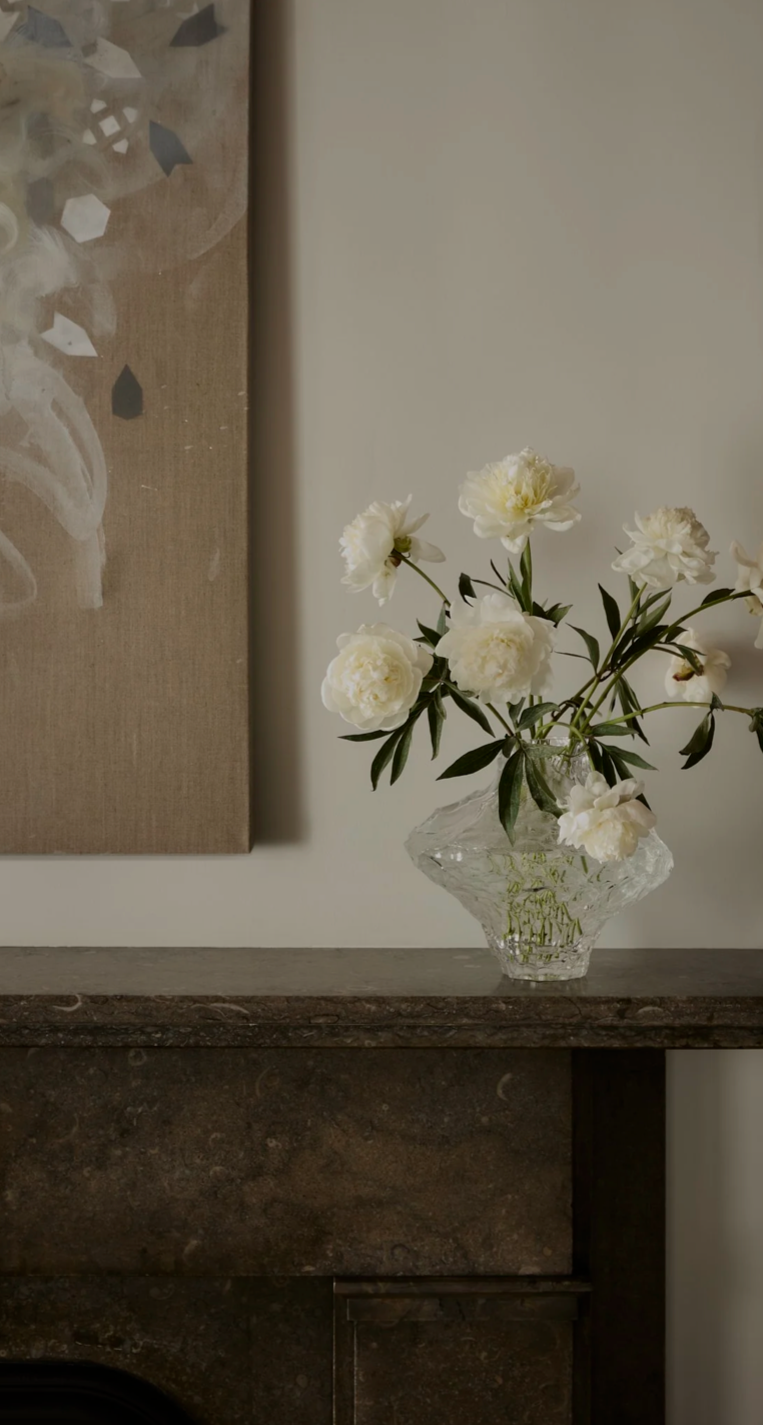 Brooklyn Heights residence detail with white peonies in a sculptural glass vase beside abstract artwork, styled by Hallie Rose Design.