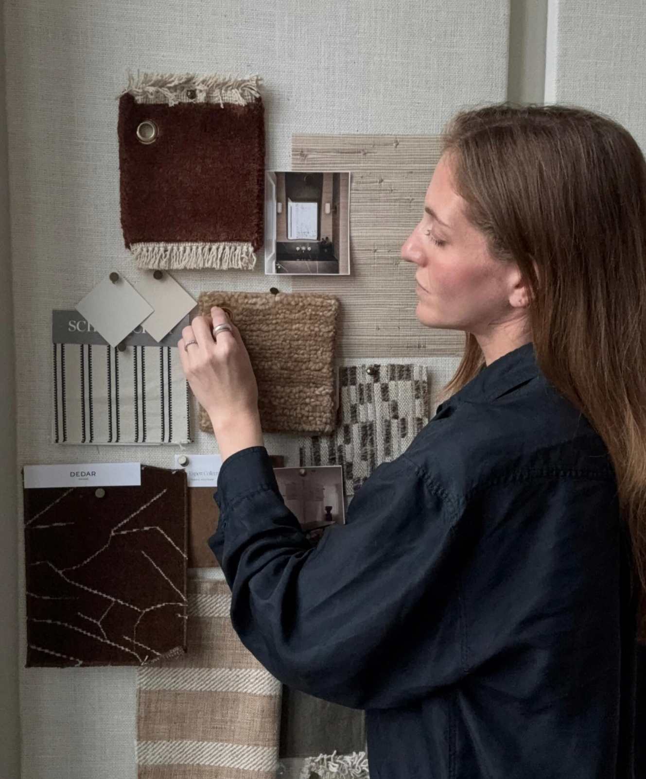 Interior designer Hallie Rose creating an interior design mood board and material palette with upholstery fabrics, textiles, and finish samples.