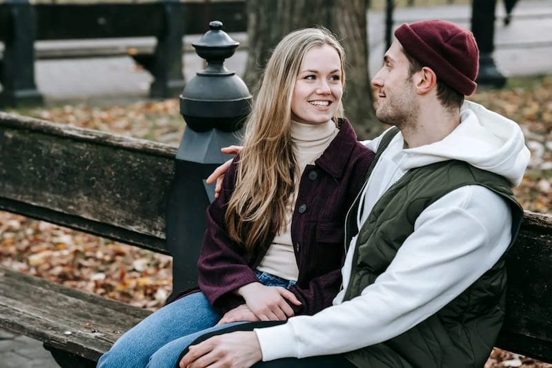 happy couple on a bench in the park