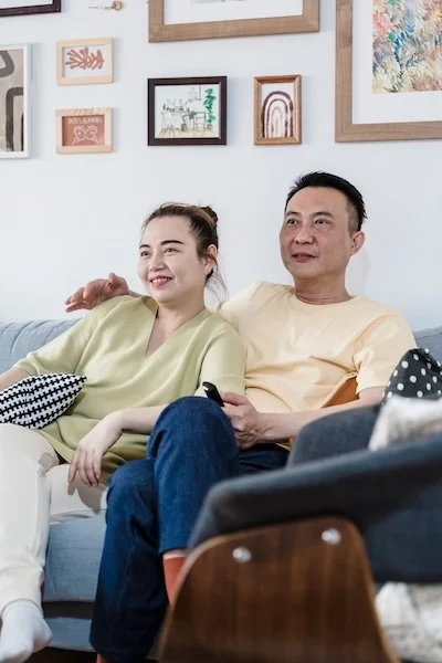 An Asian couple on the couch