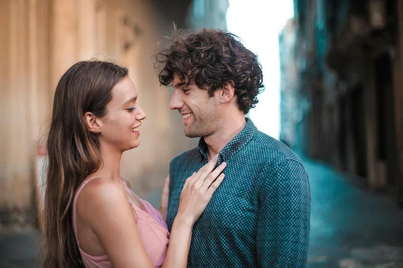 a happy couple smiling at each other