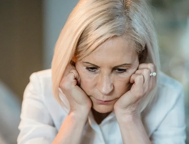 a woman looking very sad and worried