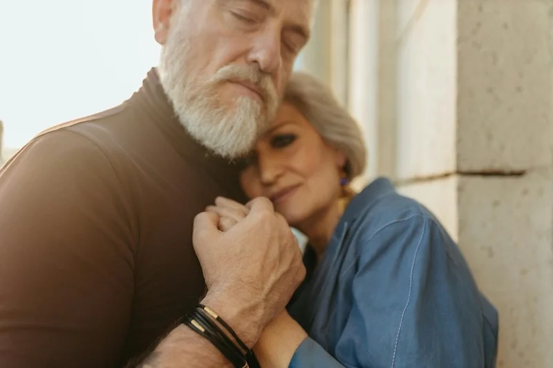 an older couple hugging