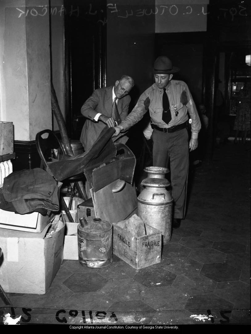 Sheriff shifts through pile of evidence during the murder trial of John Wallace, 1948 .jpeg