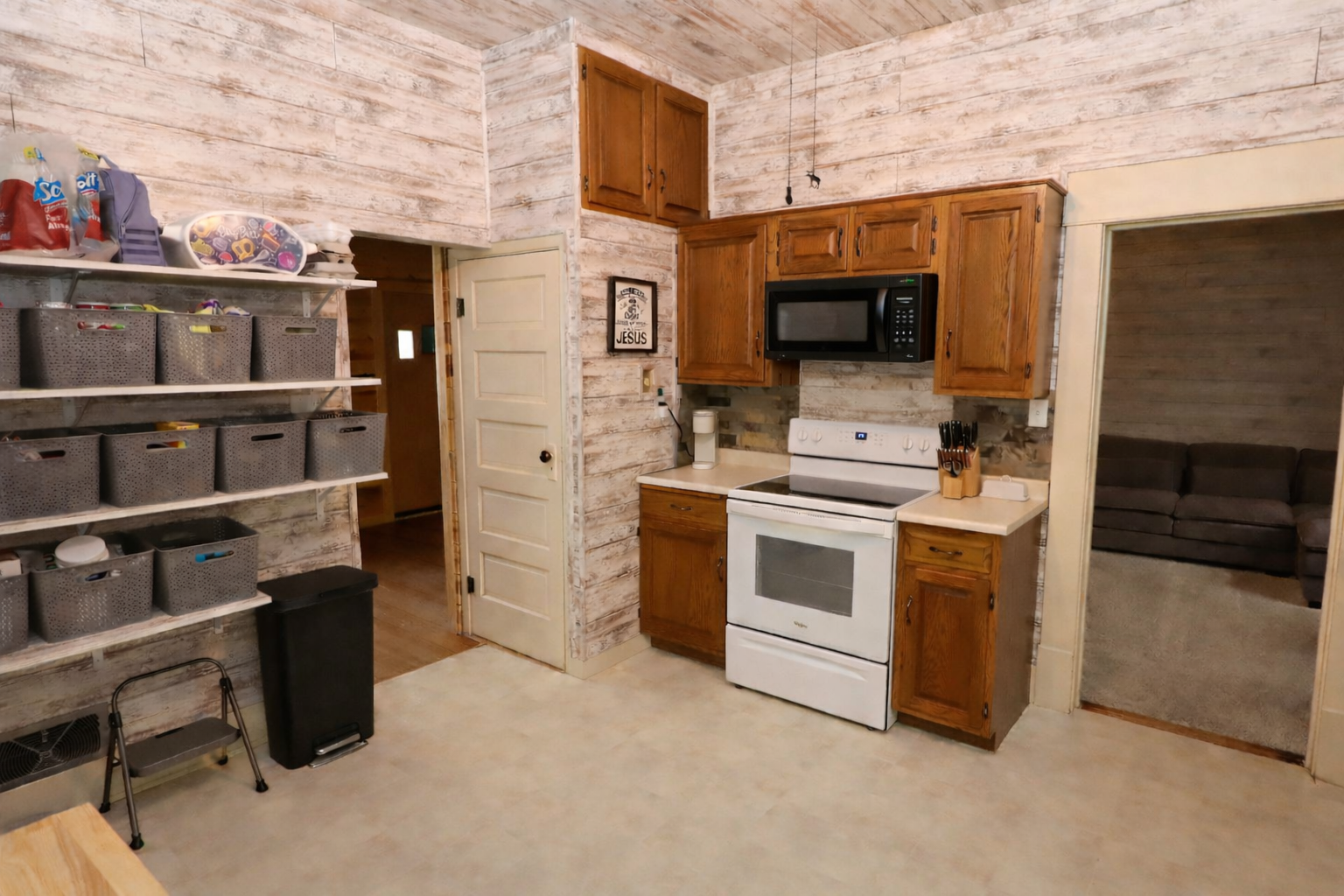Traditional kitchen with microwave and storage.png