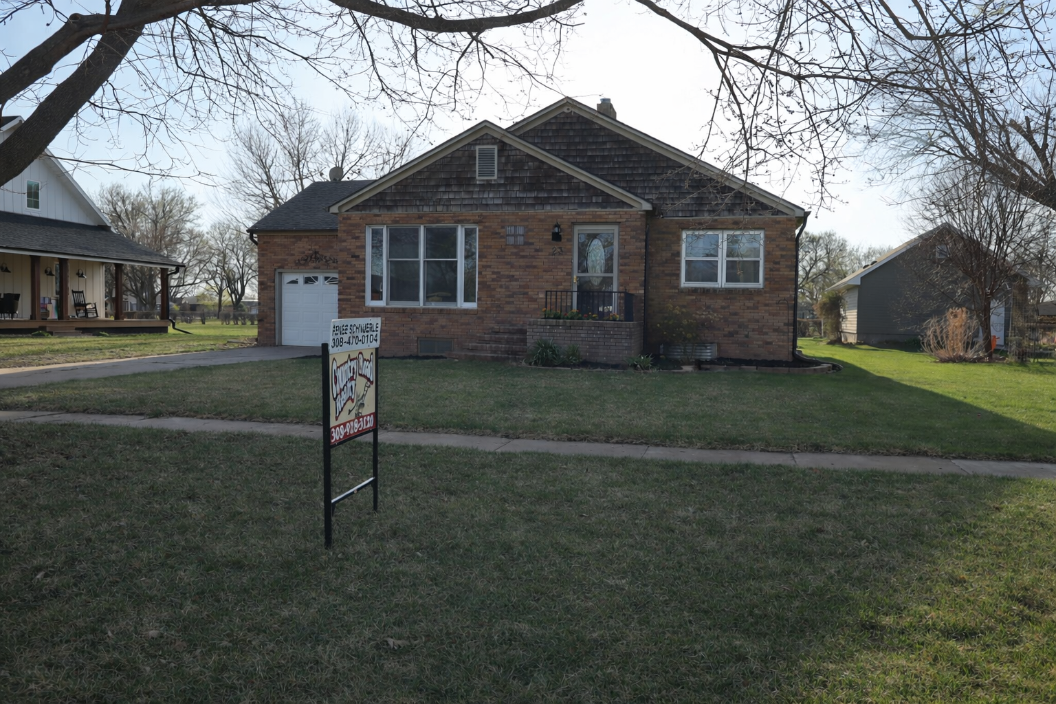 Brick house for sale at sunset.png