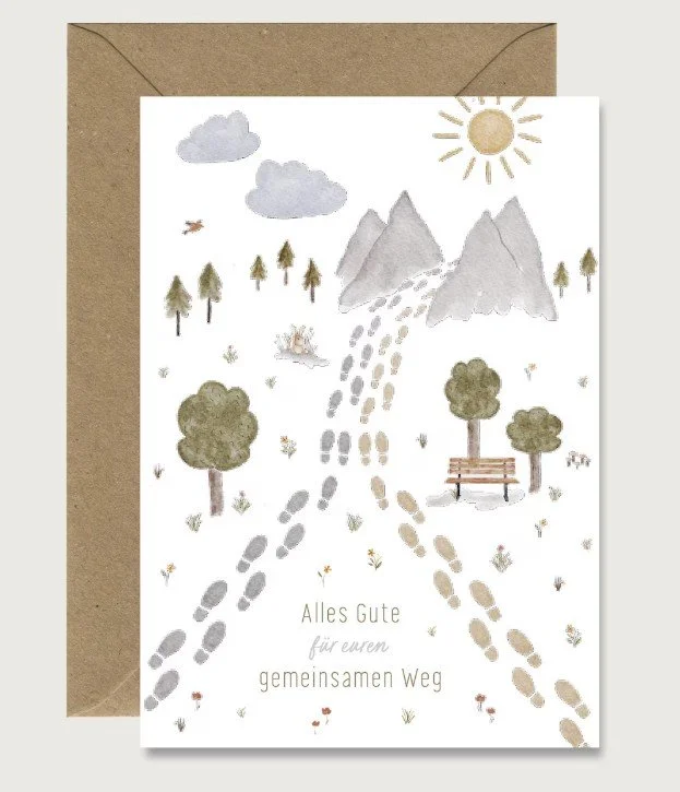 Glückwunschkarte zur Hochzeit im Aquarell-Stil mit einem Motiv aus zwei Fußspuren, die sich treffen und als ein gemeinsamer Weg in Richtung Berge führen. Text: „Alles Gute für euren gemeinsamen Weg“.