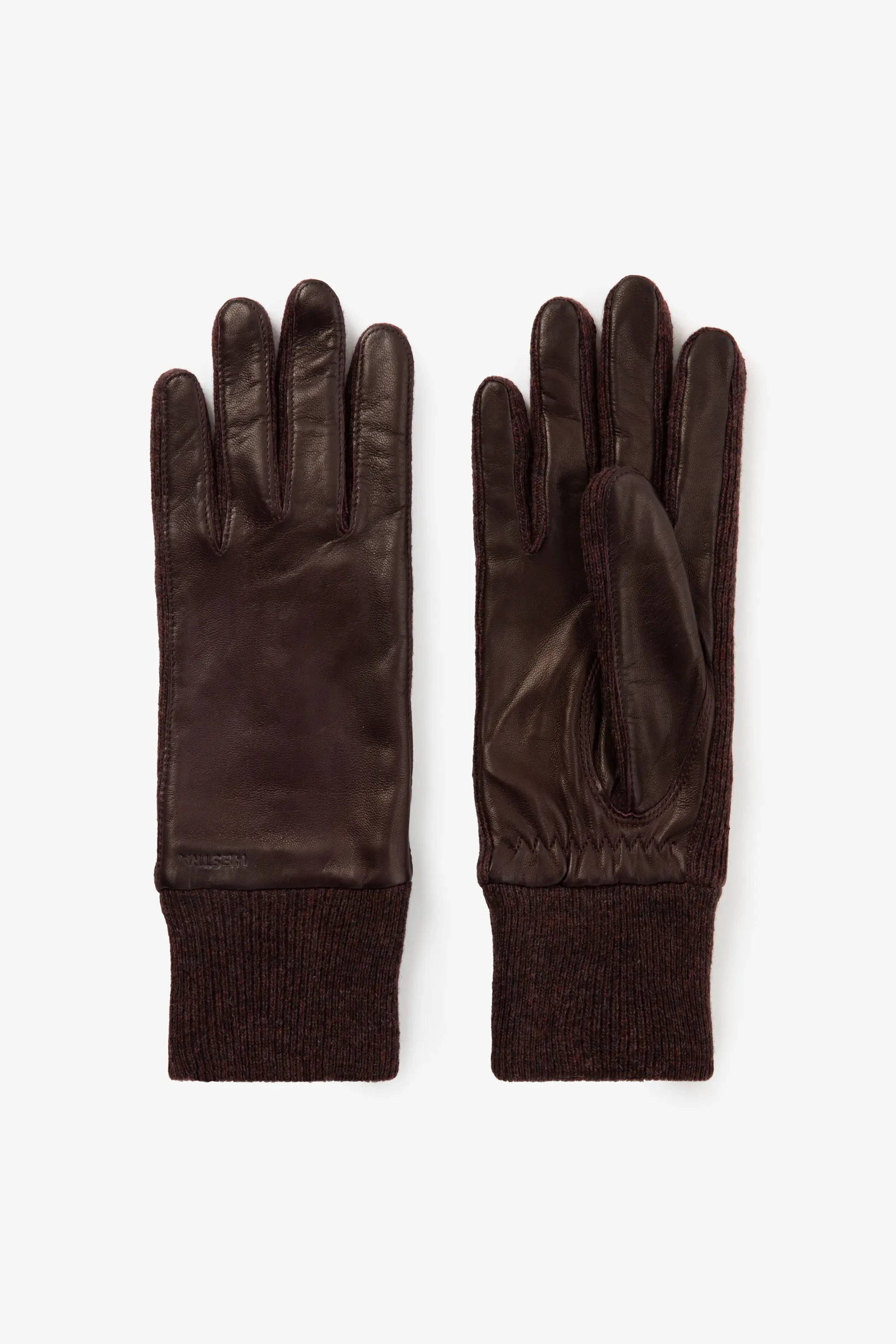 Ein Paar dunkelbraune Lederhandschuhe von Hestra. Sie verfügen über glattes Leder und lange, farblich passende Strickbündchen.