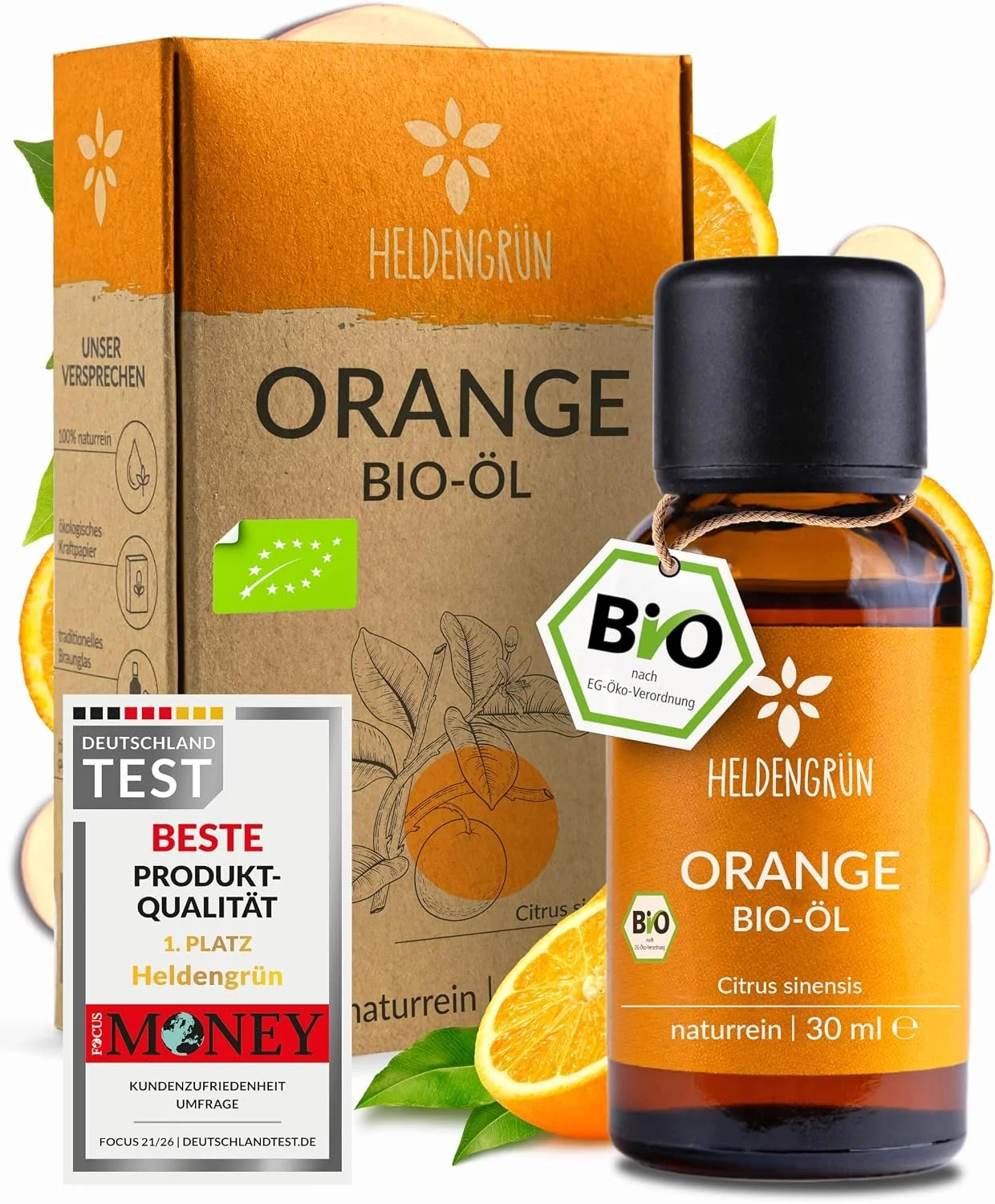 HeldenGrün Orange Bio-Öl (30ml) in brauner Glasflasche neben dazugehöriger Pappverpackung, dekoriert mit frischen Orangen und versehen mit "Deutschland Test"-Siegel.
