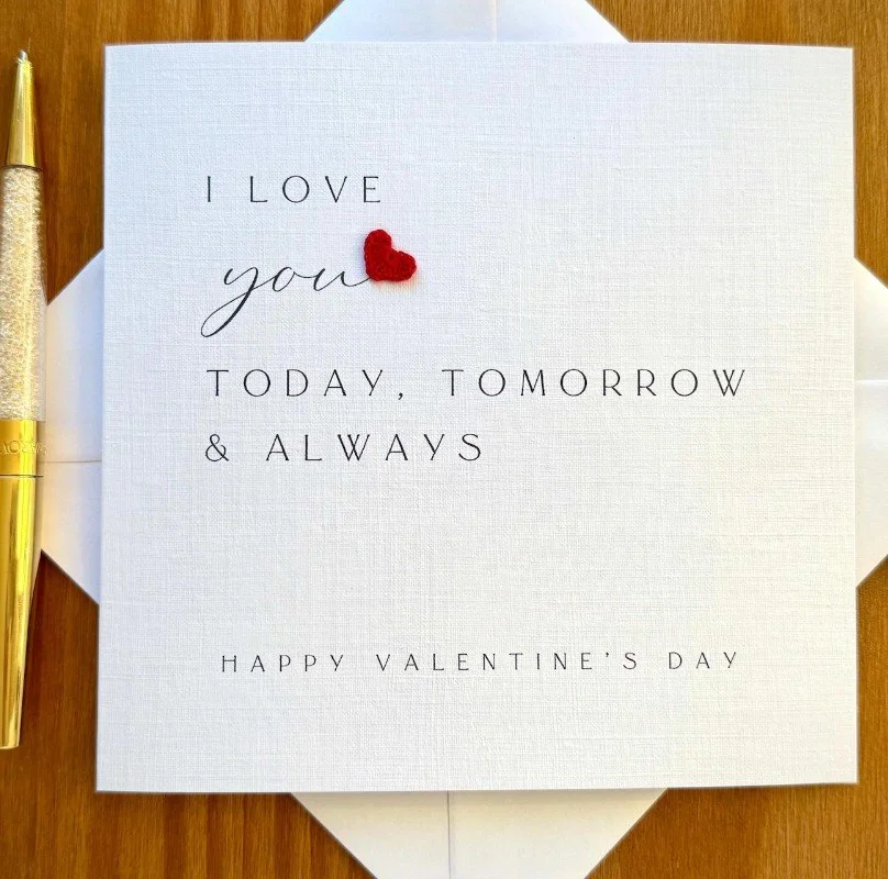 Quadratische weiße Karte mit einem kleinen roten Häkel-Herz und dem Text „I love you today, tomorrow & always - Happy Valentine's Day“.