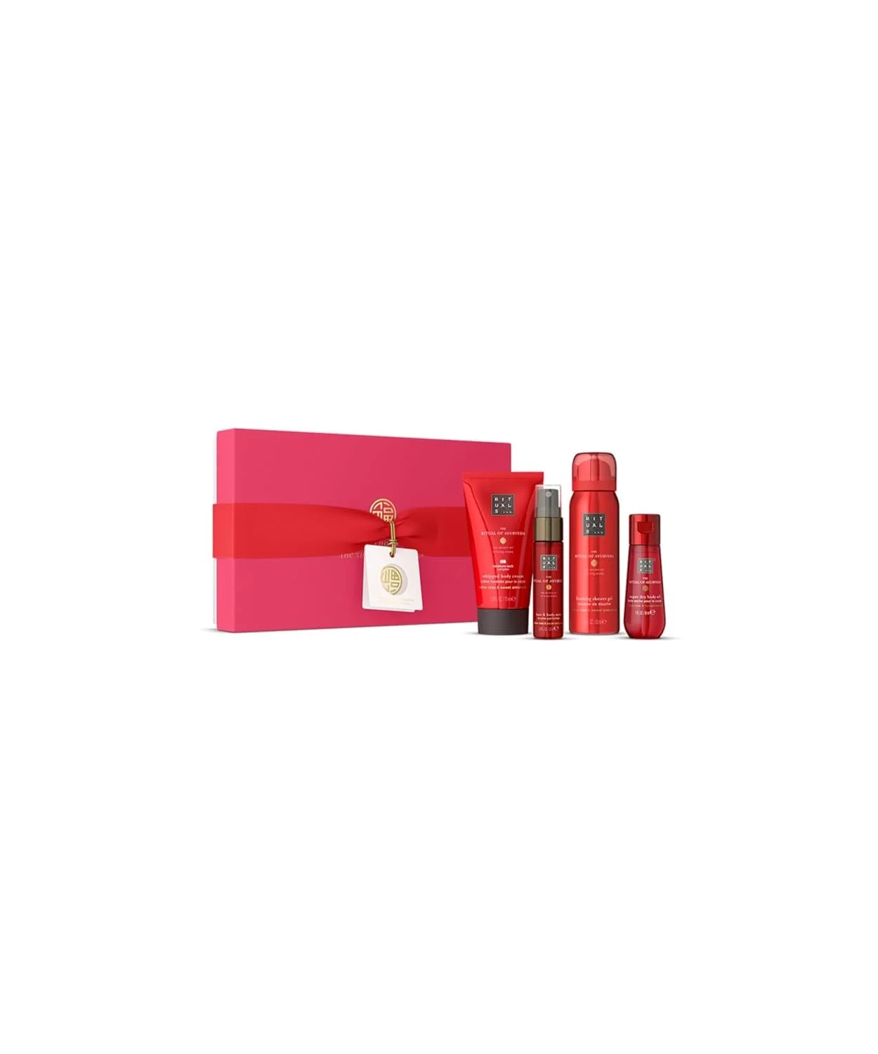 Geschenkset "The Ritual of Ayurveda" von Rituals. Eine pinkfarbene Box mit Schleife, daneben vier rote Produkte: Bodycreme, Duschschaum, Haar-/Körperspray und ein weiteres kleines Fläschchen.