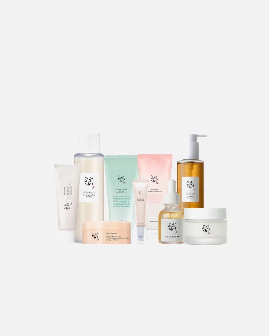 Ein Set aus neun Hautpflegeprodukten der Marke Beauty of Joseon. Die Flaschen, Tuben und Tiegel in sanften Pastell- und Erdtönen sind auf einem weißen Hintergrund gruppiert.