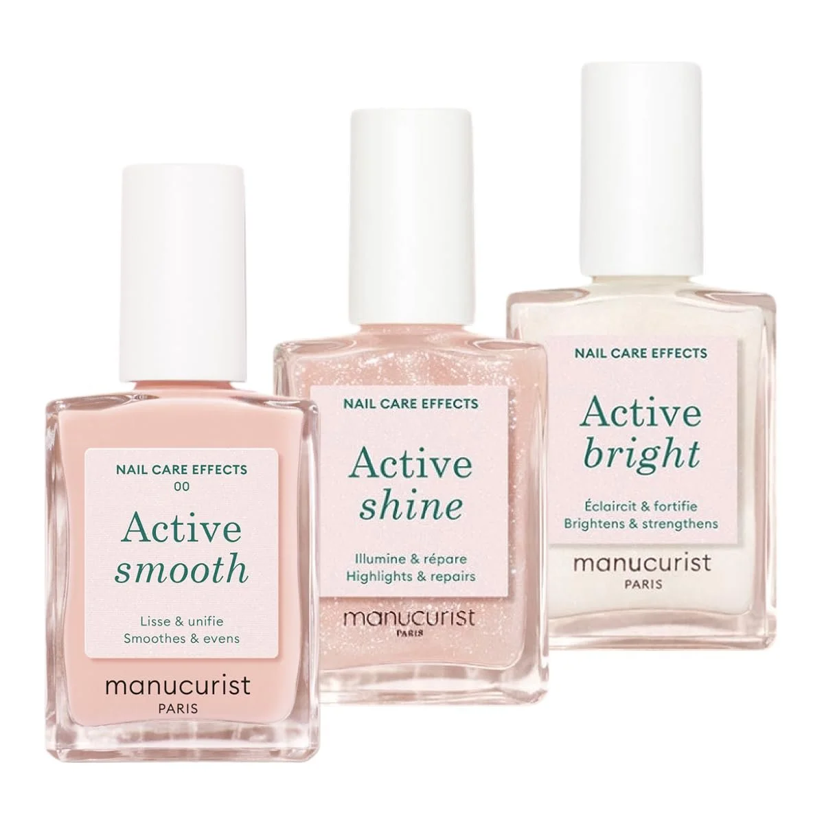Drei Flaschen Nagellack von Manucurist mit weißen Kappen nebeneinander: Das deckende Altrosa „Active smooth“, das glitzernde Rosé „Active shine“ und das milchig-weiße „Active bright“.