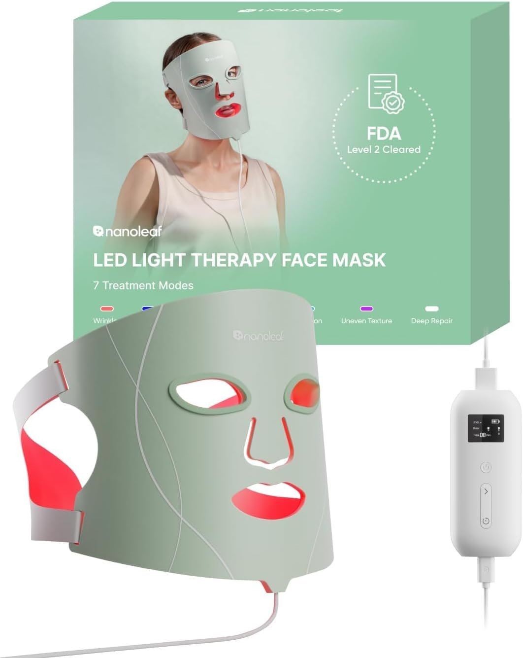 Nanoleaf LED-Lichttherapie-Gesichtsmaske in Salbeigrün mit aktiviertem rotem Licht an Augen-, Mund- und Kinnpartie, davor die Verpackung mit "FDA Level 2 Cleared"-Siegel und Angabe von 7 Behandlungsmodi, rechts das Steuergerät mit Display.