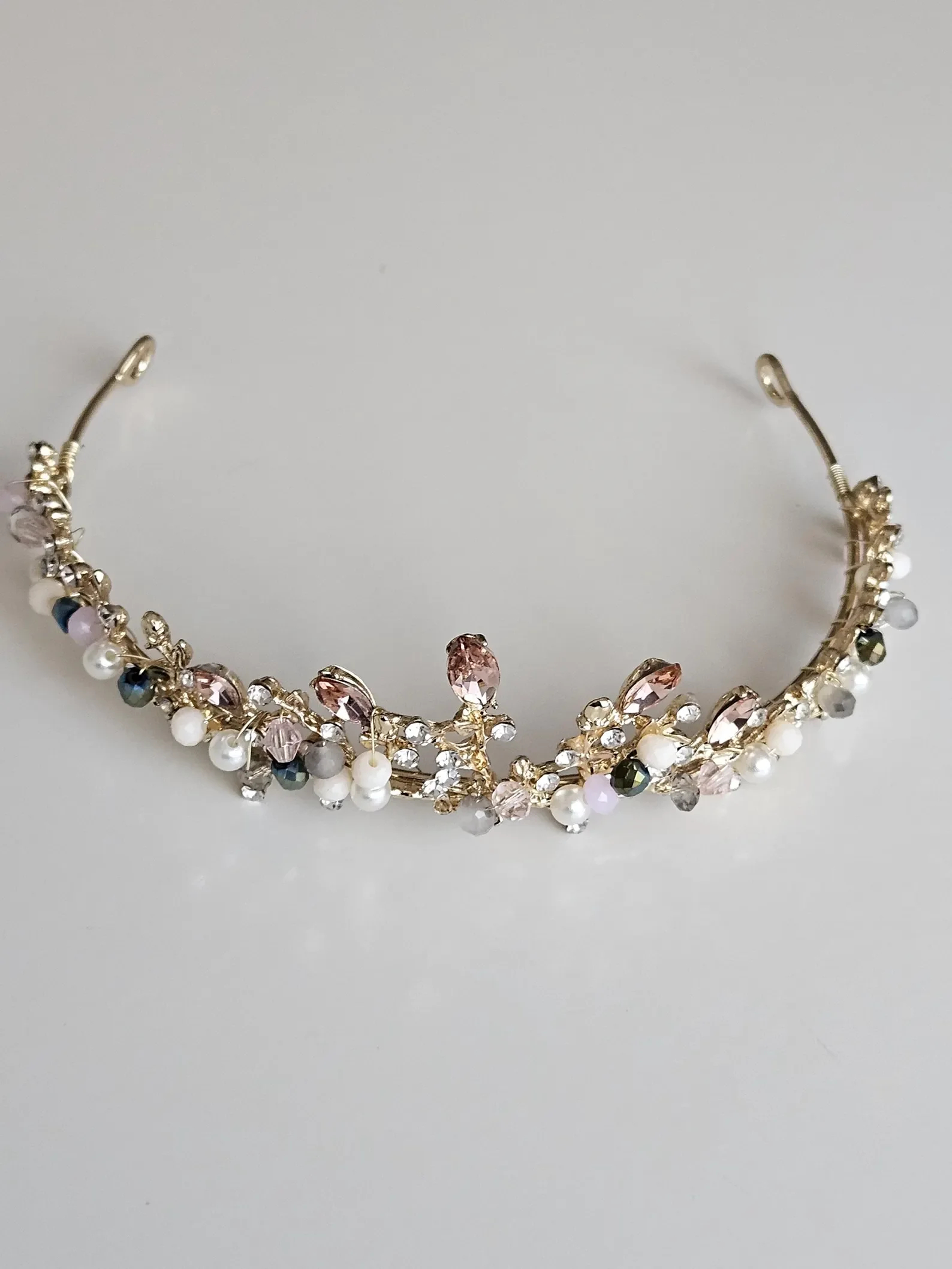 Goldenes Diadem für die Hochzeit mit weißen Perlen, Kristallen und zarten rosafarbenen Schmucksteinen.