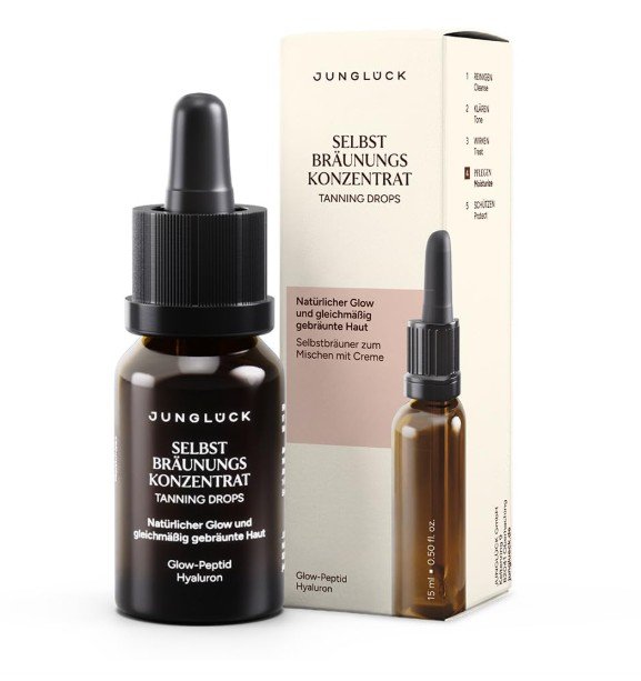 Braunes Glasfläschchen und weiße Umverpackung des Junglück "Selbstbräunungs Konzentrat" (Tanning Drops) mit Pipette.