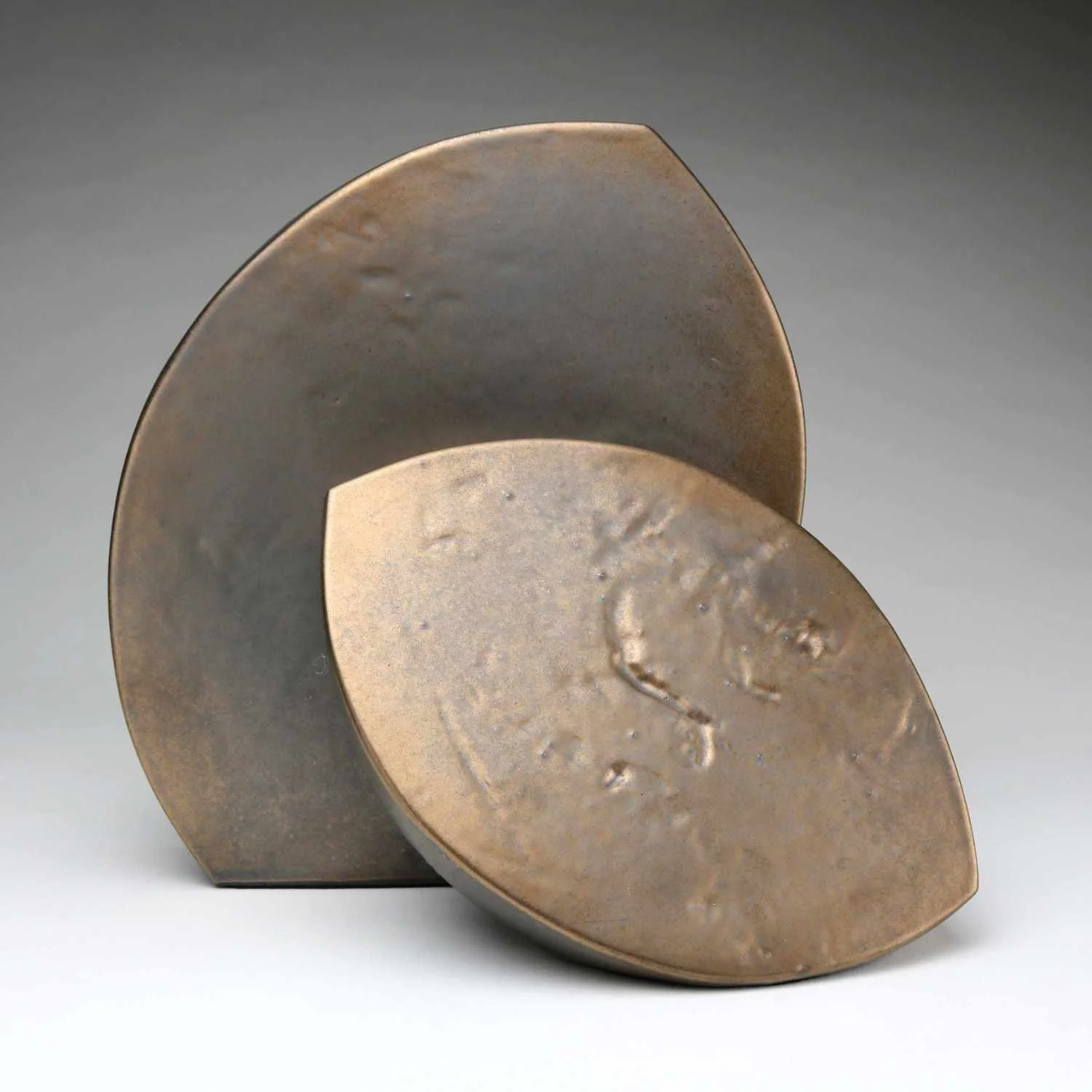 Abstract Ceramic Sculpture of two curved forms in bronze glaze