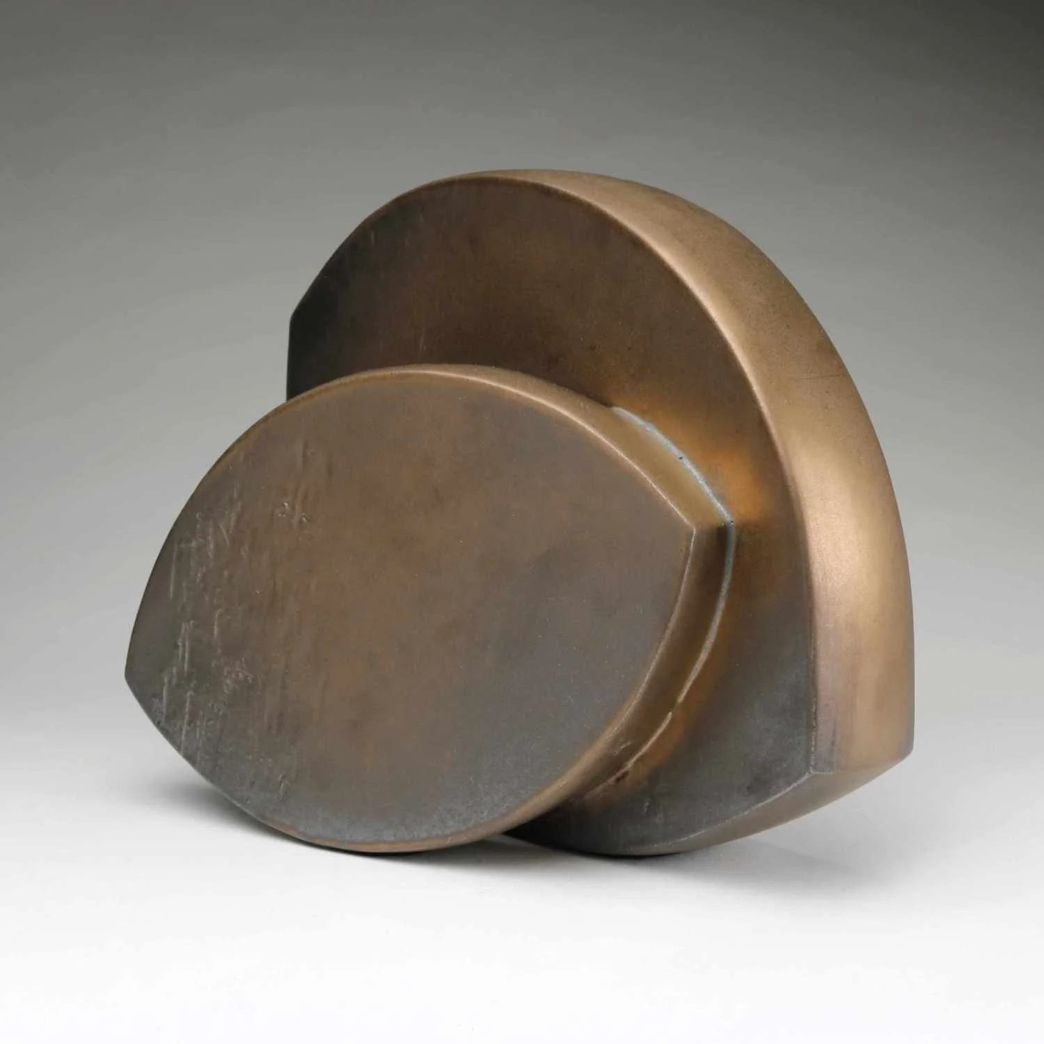 Abstract Ceramic Sculpture of two curved forms in bronze glaze