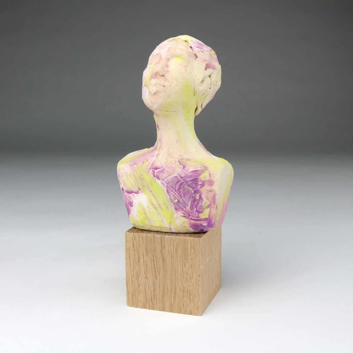 Awaken, a ceramic bust by Lisa Hilton featuring yellow and lavender tones with textured glaze from the Women in Conversation collection.