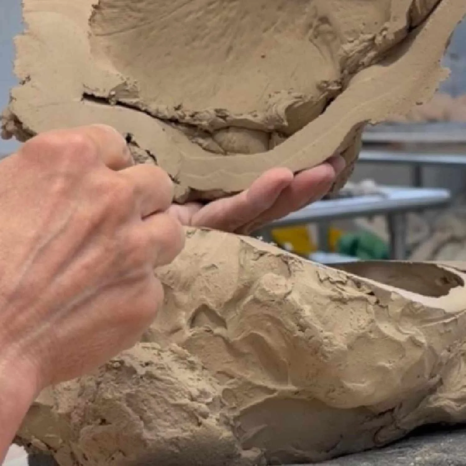 Close-up of Lisa Hilton hand-building a hollow ceramic cloud form, showing slab construction and textured surface development