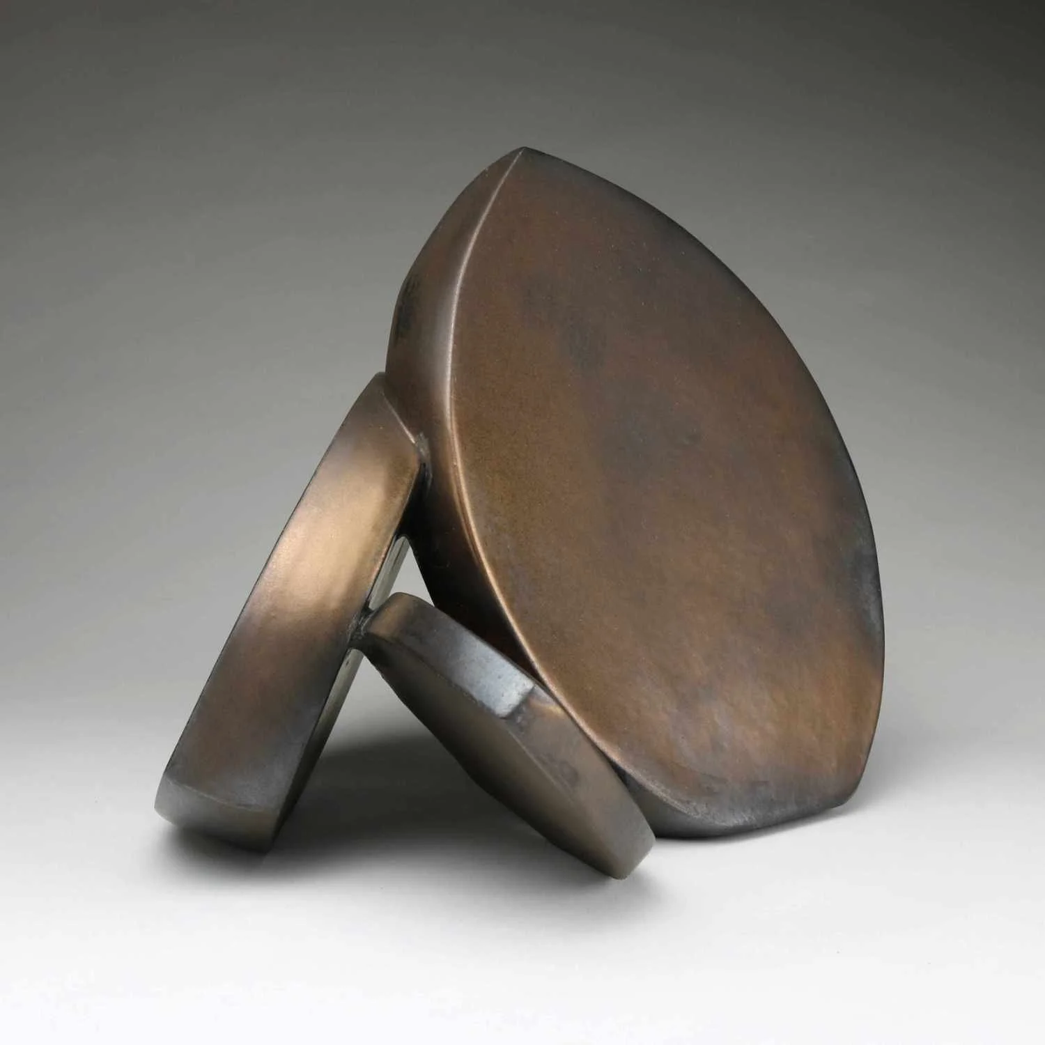 Abstract Ceramic Sculpture of three curved forms with bronze glaze