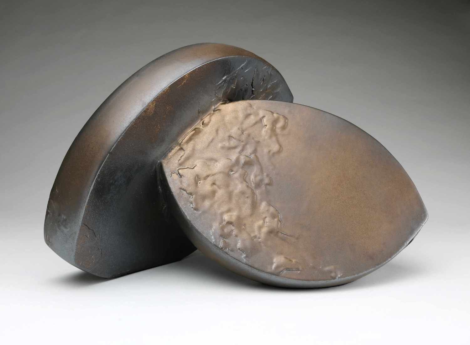 Abstract Ceramic Sculpture of two curved forms in bronze glaze