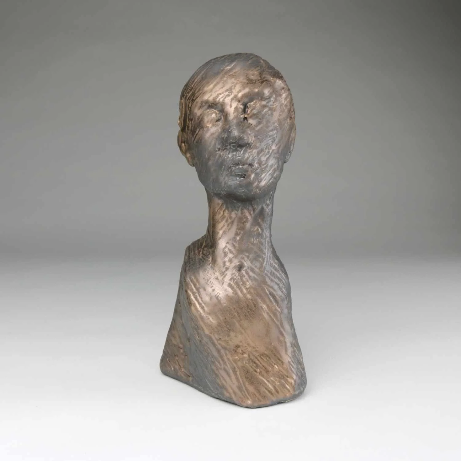 Forge, a textured ceramic bust by Lisa Hilton with bronze glaze expressing movement and depth from the Women in Conversation collection.