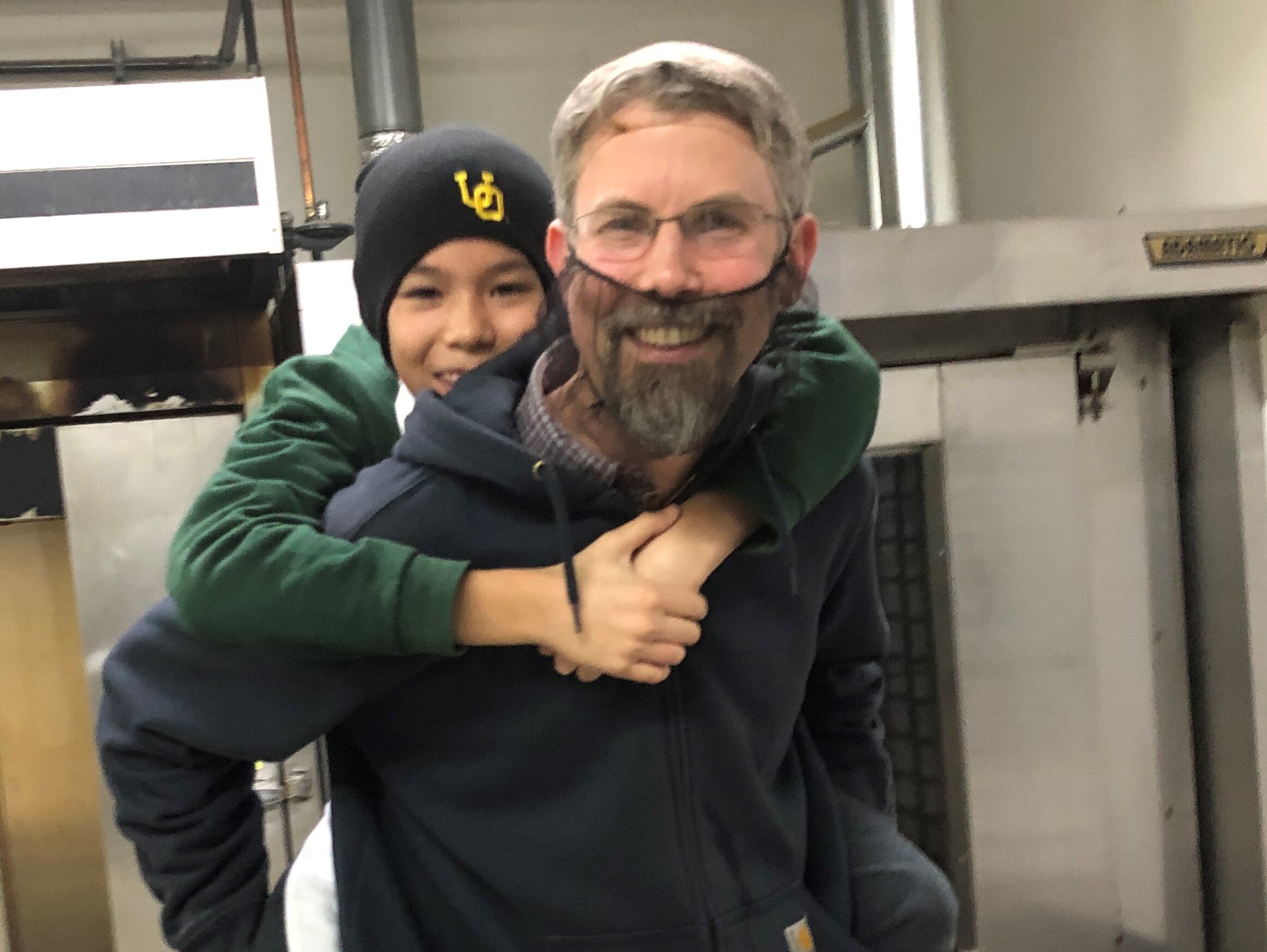 2020 Dave's story- Kalei and Dave Piggy Back in oven room.jpg