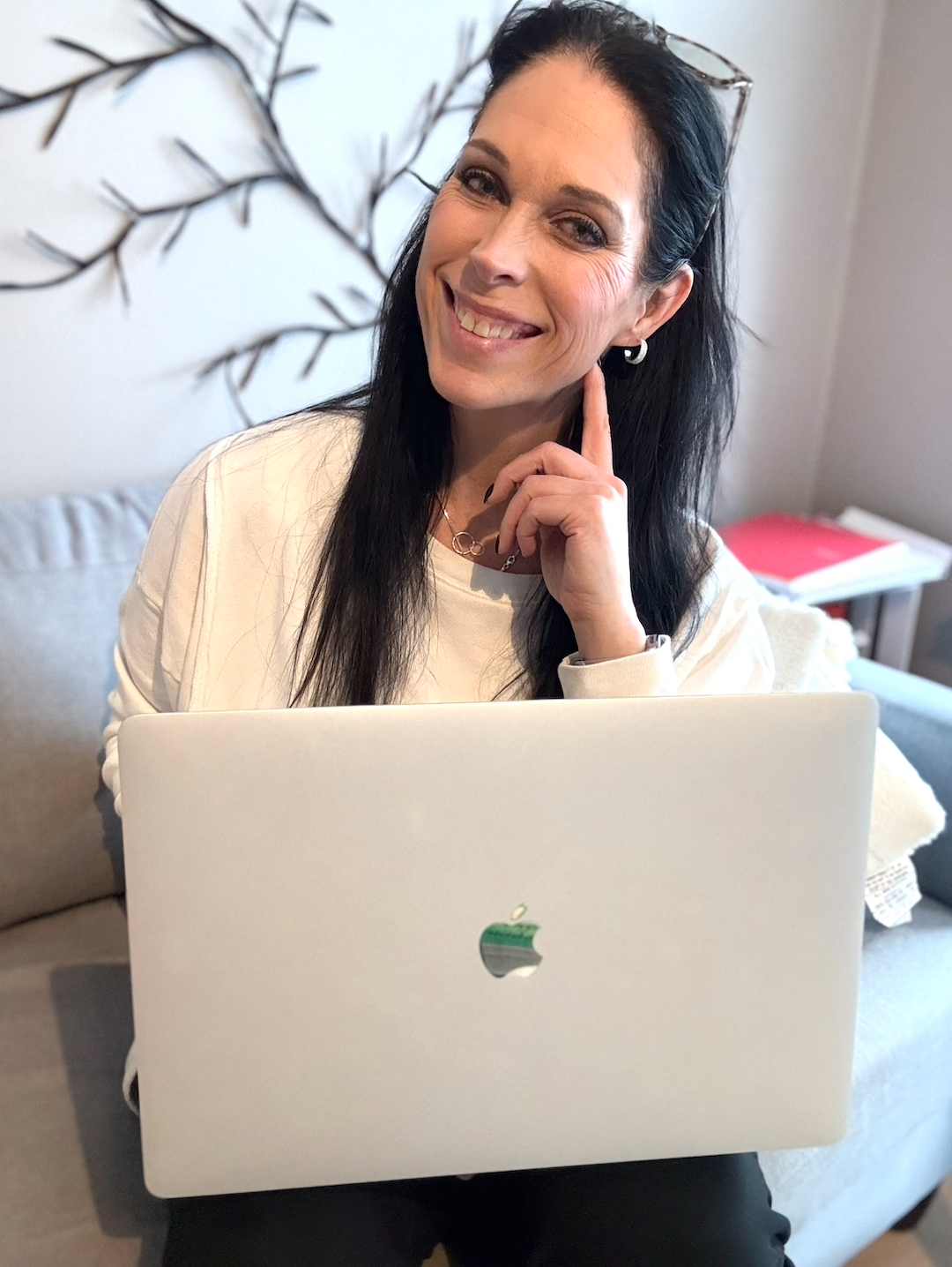 Dr. Renee sitting on couch with her computer