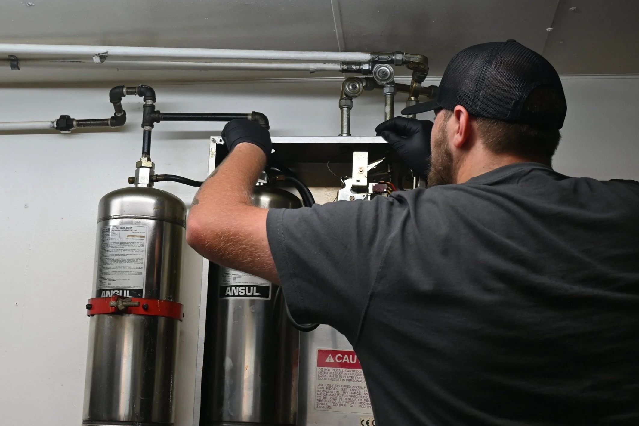NES technician providing suppression system service