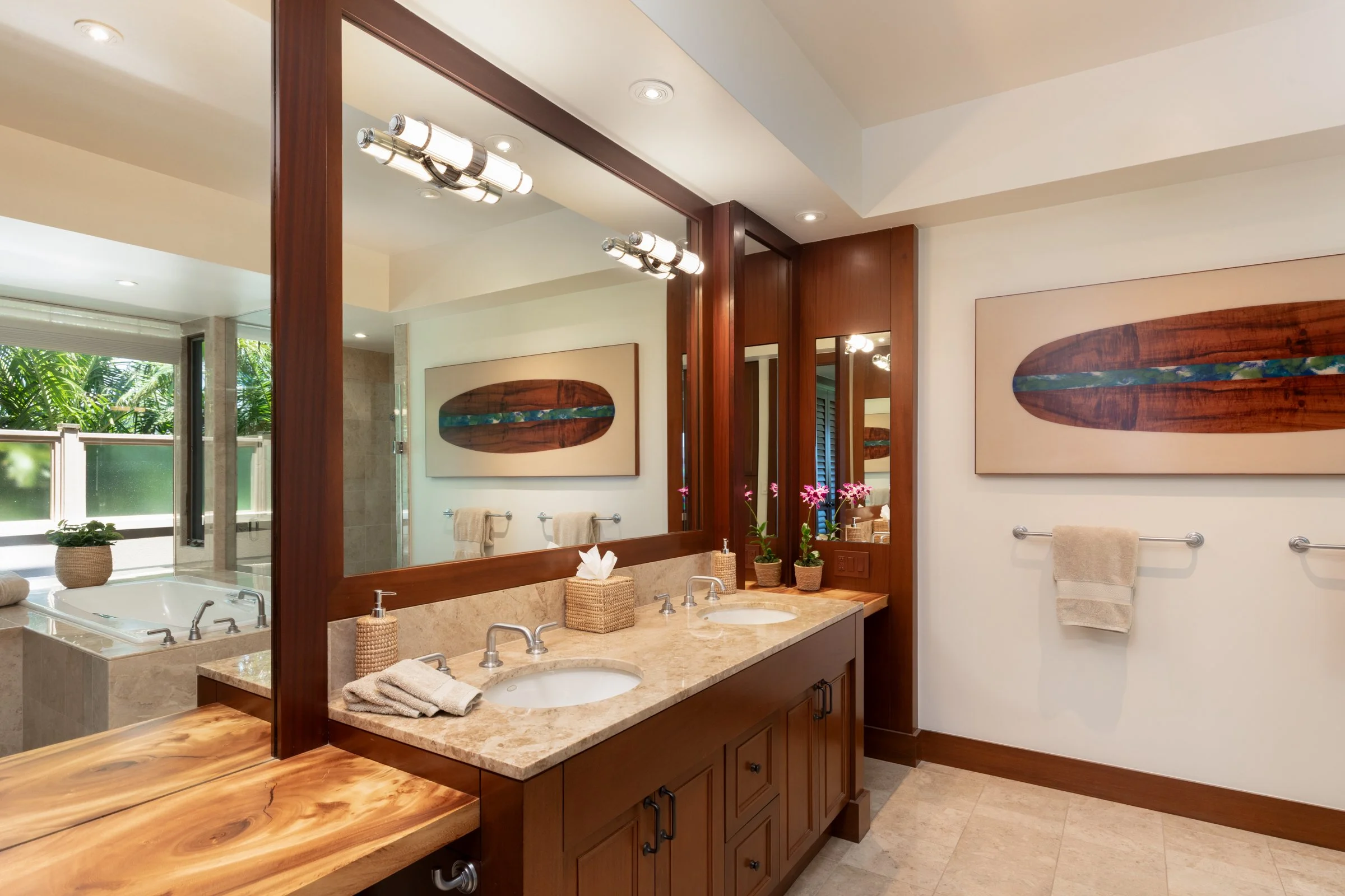 Primary bathroom has dual vanities, large centered soaking tub and private outdoor sitting area.
