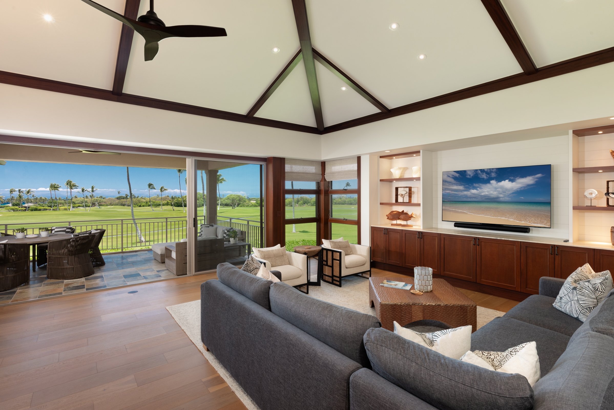 Great room features high vaulted ceilings with custom built-in media center.