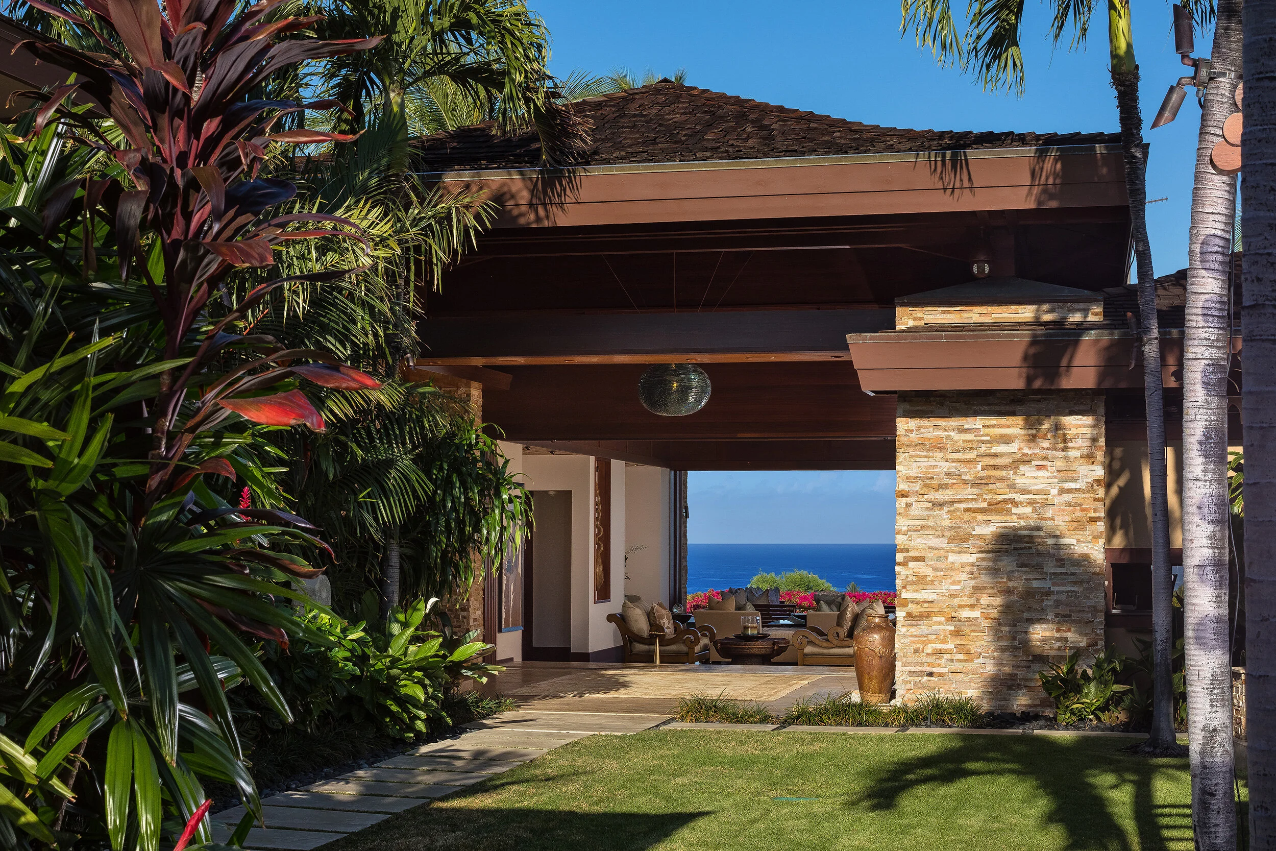Interior courtyard features colorful landscaping with paved walkways to the main entry, guest bedroom and separate media room.