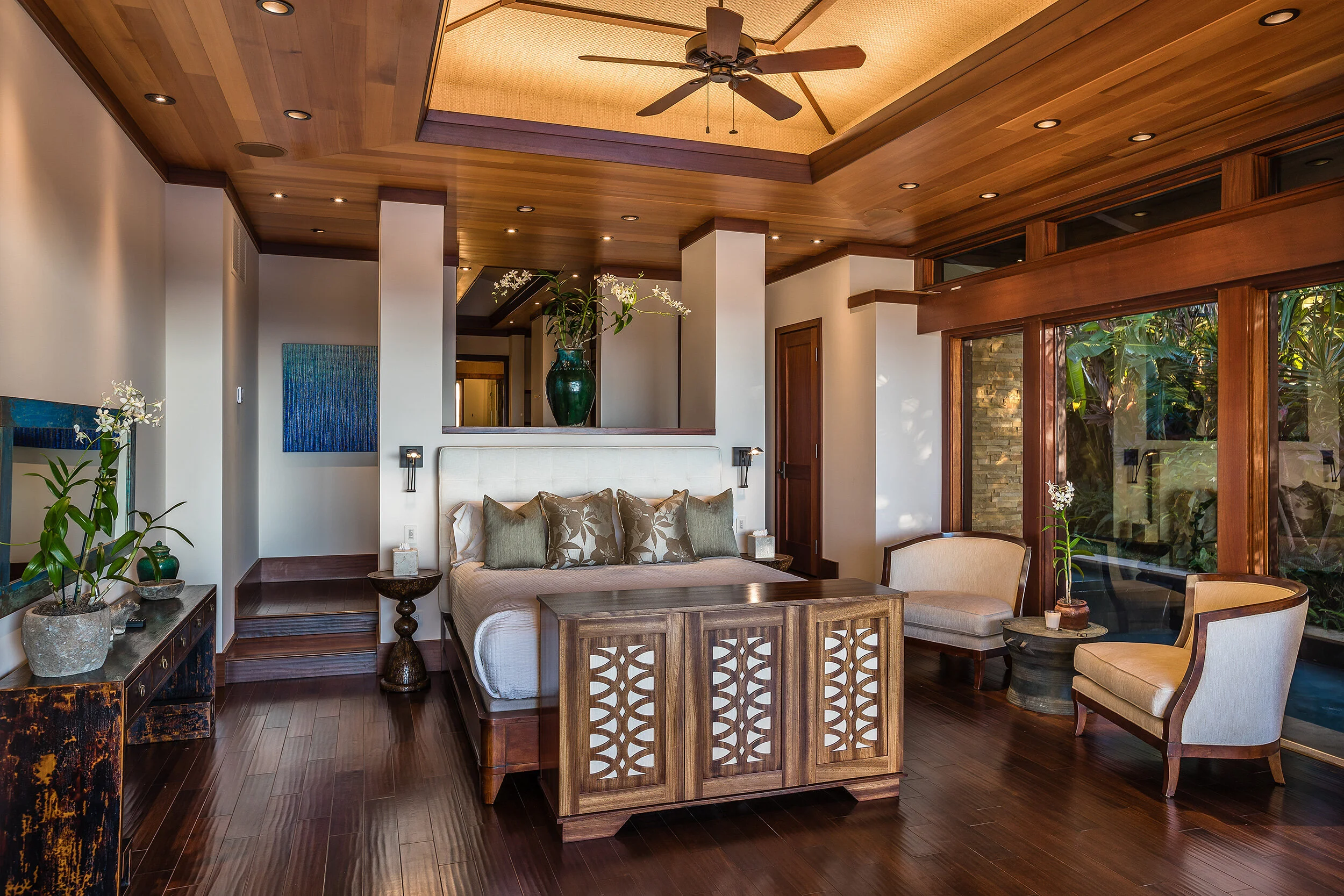 Master suite with private office showcases large windows that overlook the peaceful water feature.