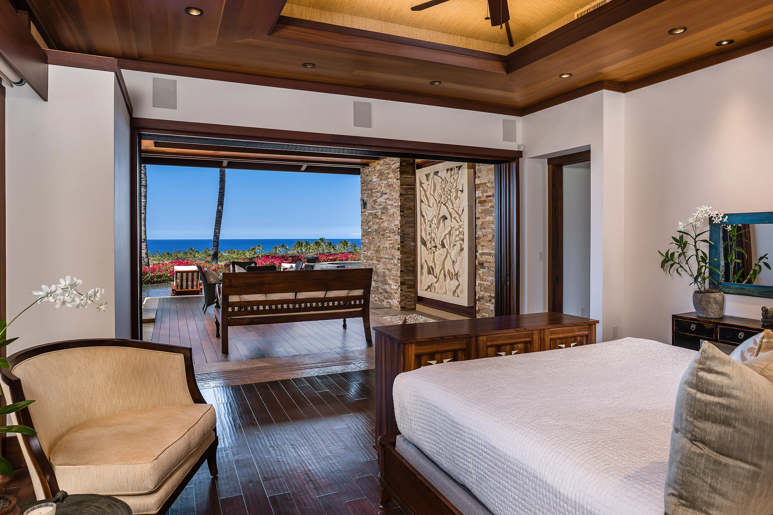 Master bedroom opens to a hardwood lānai and pool deck with amazing ocean and golf course views.